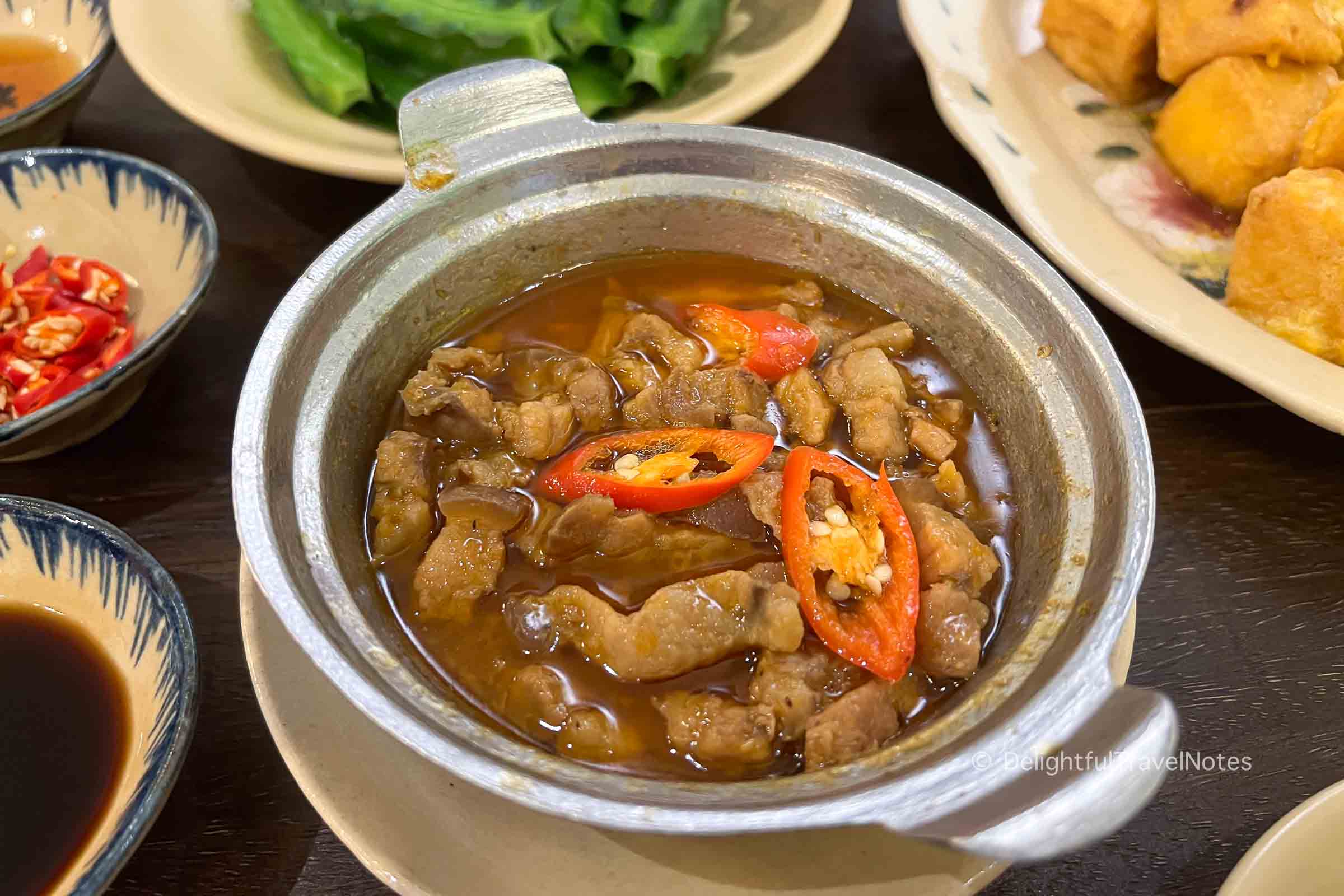 a bowl of braised pork with fermented sauce at Quan Bui restaurant in Saigon