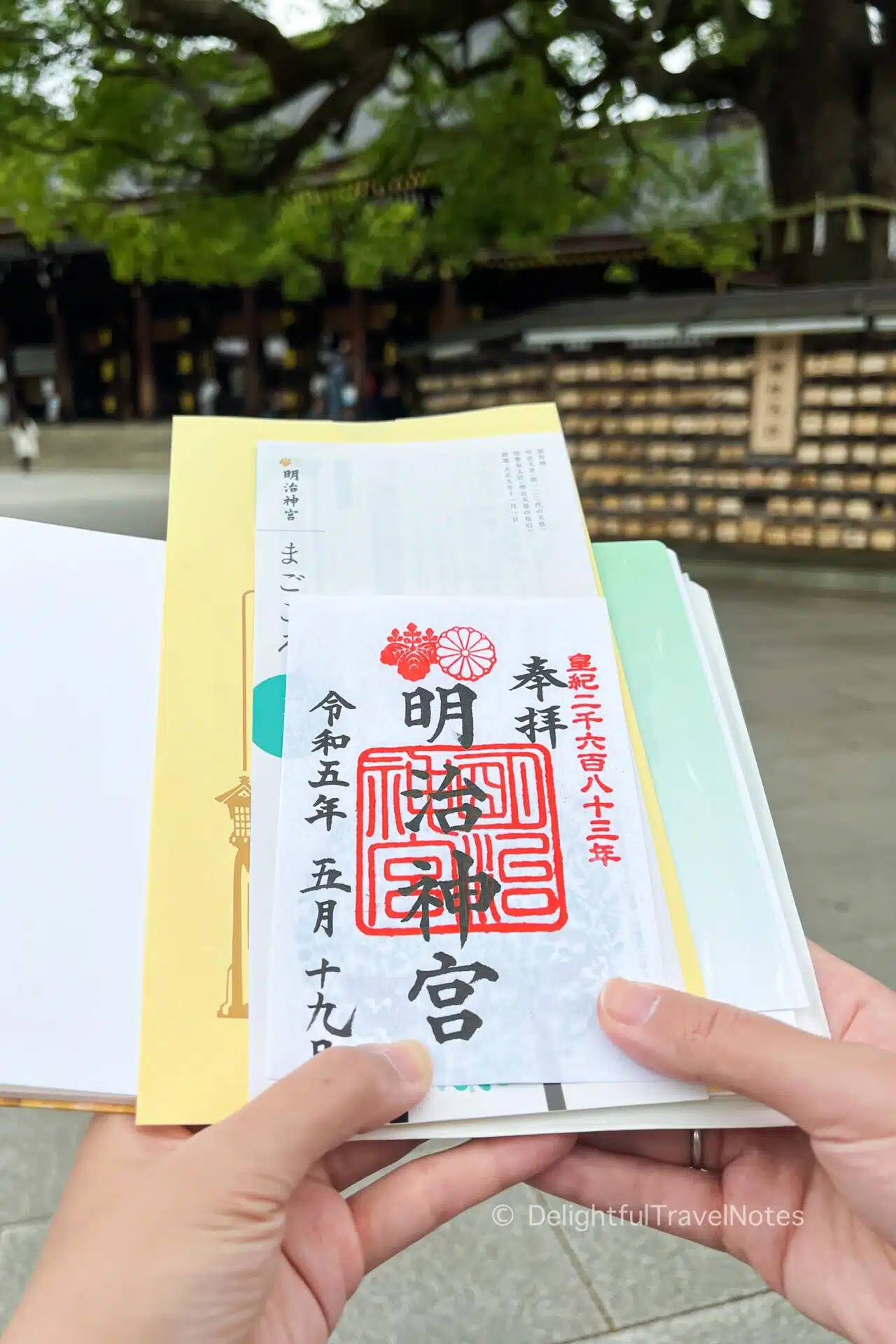 a page with Meiji Jingu goshuin with the temple in the background