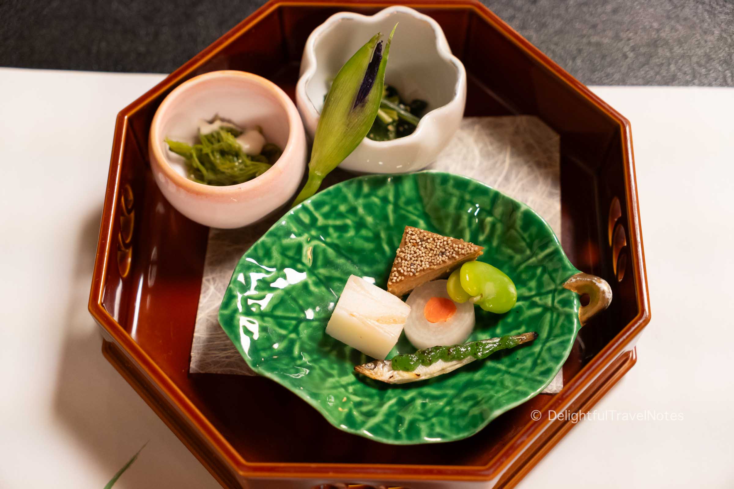 a tray of vegetable morsels in the second course at Hanasaki Manjiro restaurant in Kyoto.
