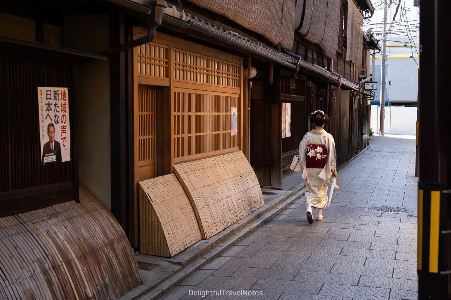 a street in Gion, Kyoto with a woman in kimono