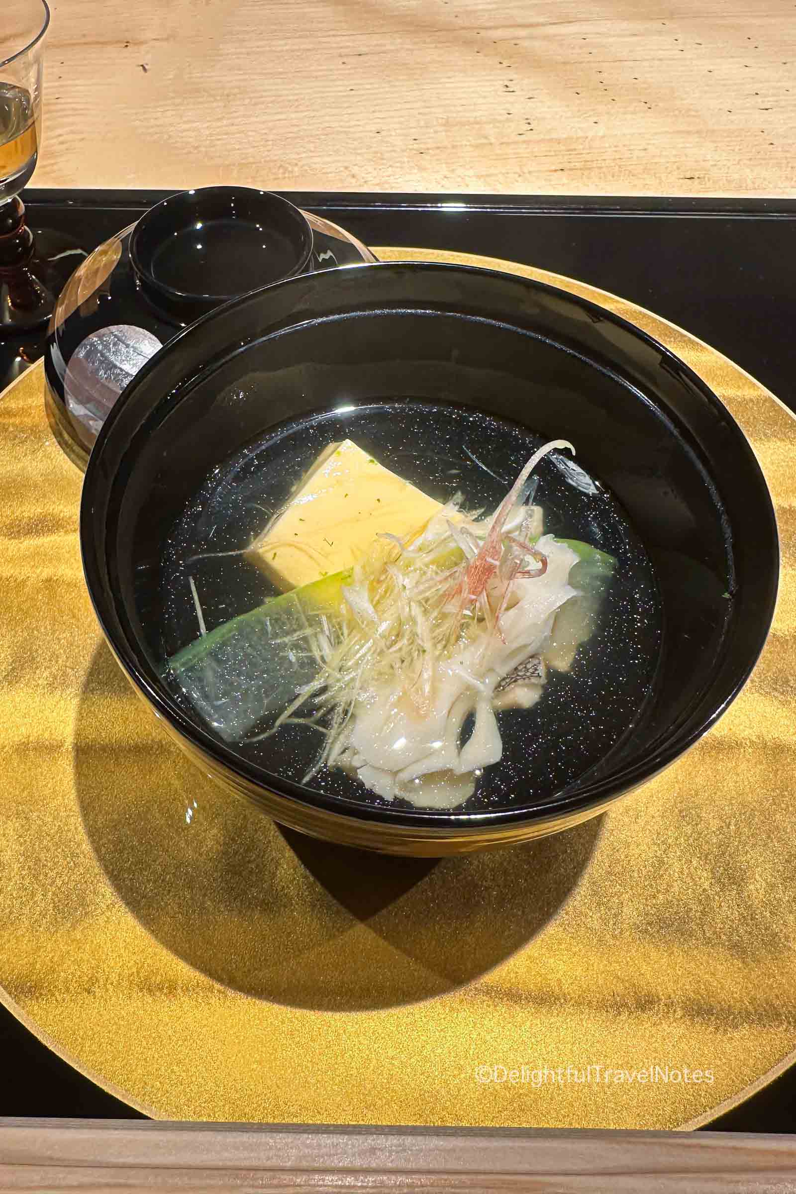 a bowl of suimono soup in kaiseki dinner at Madoka no Mori ryokan