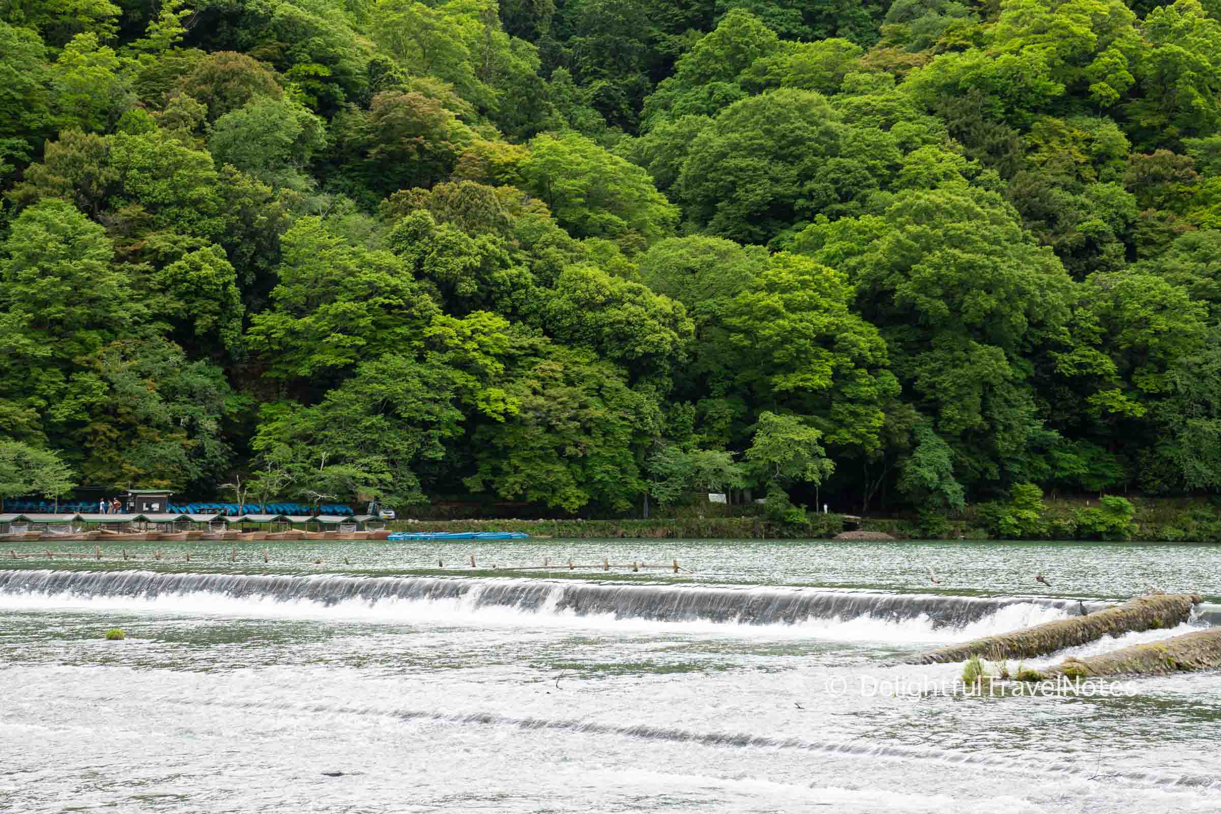 view of Katsura River with the mountains as a backdrop in Arashiyama Kyoto.