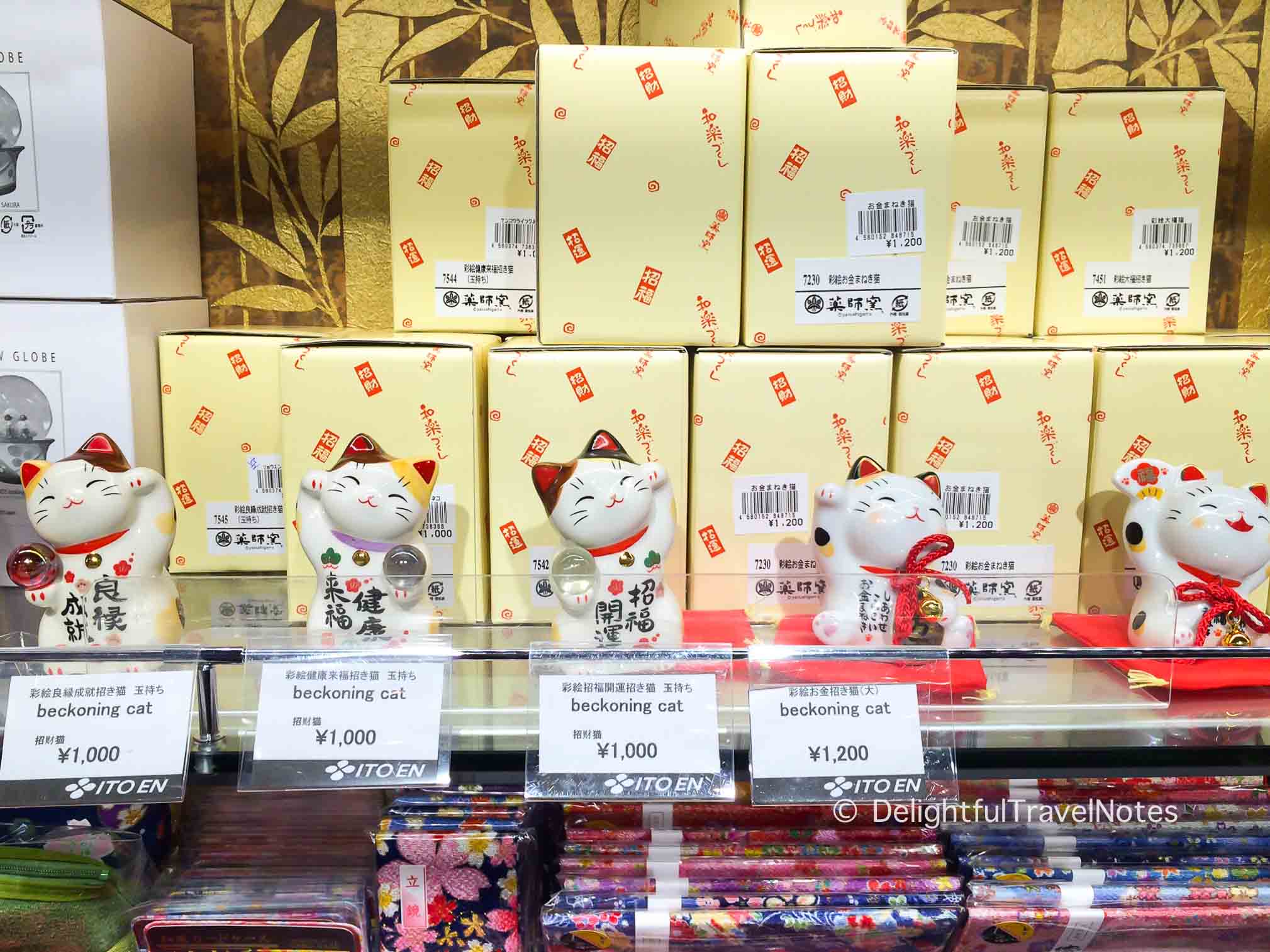 a shelf of lucky beckoning cats in a souvenir shop in Japan.
