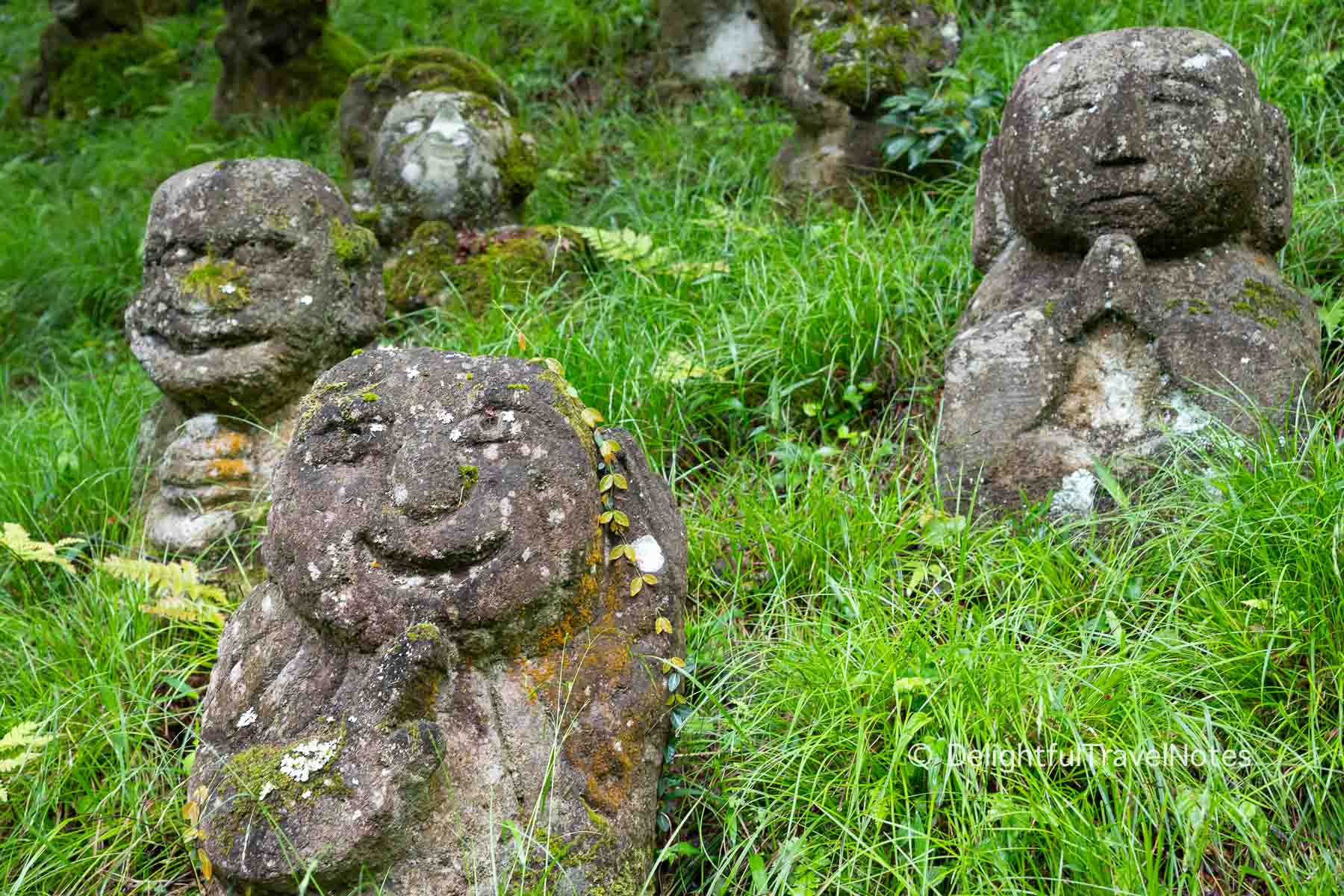 Several stone statues on the hill at Otagi Nenbutsu-ji temple in Kyoto.