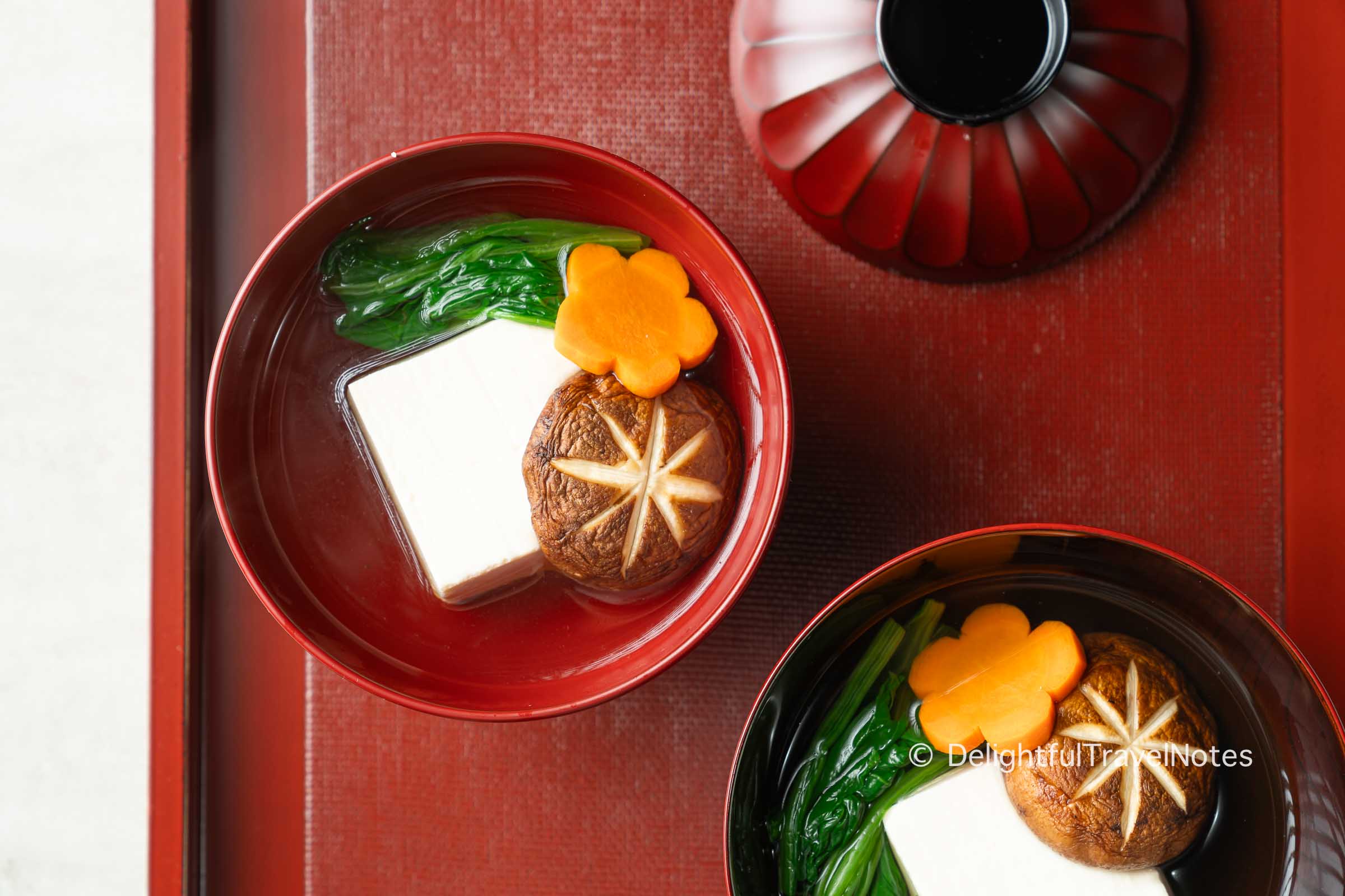 two Japanese lacquered bowls with suimono clear soup.