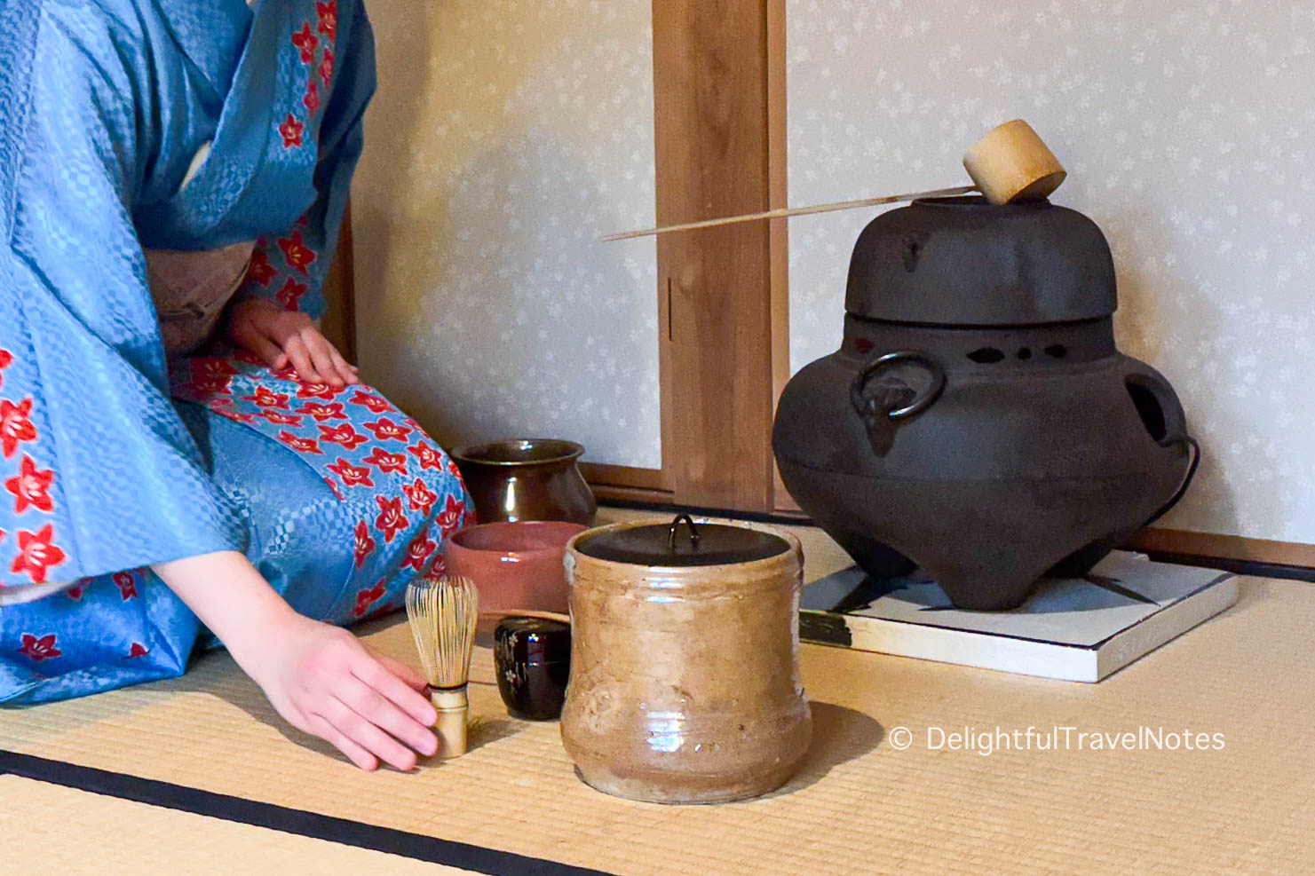 a lady in the process of preparing matcha in tea ceremony.