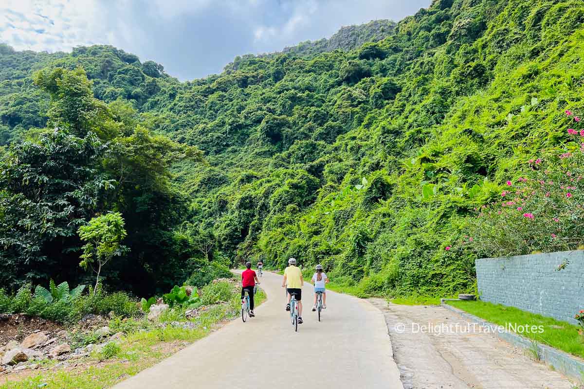 group of people cycling in Viet Hai village on Cat Ba island.