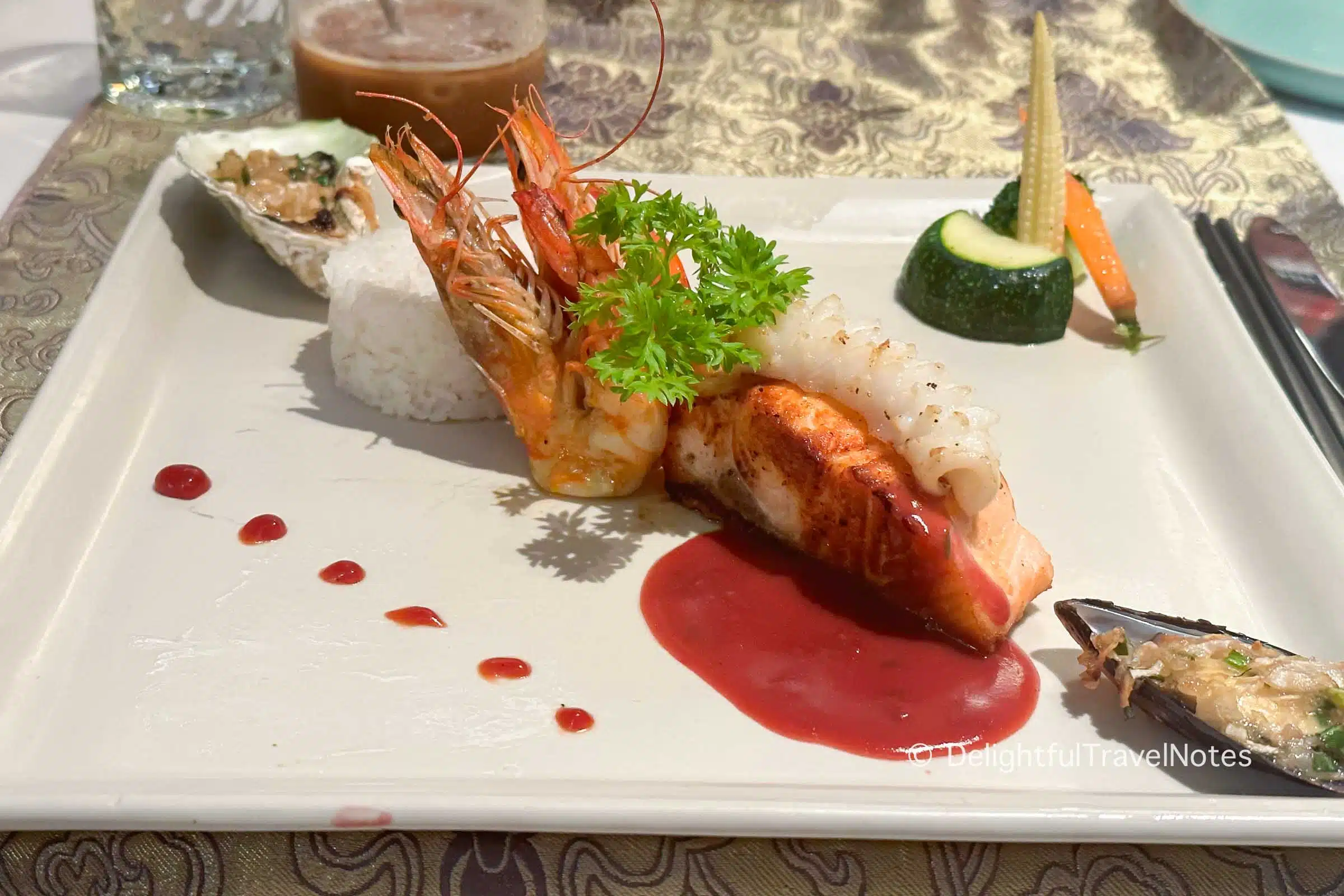 a plate with rice and assorted seafood including salmon and shrimp.