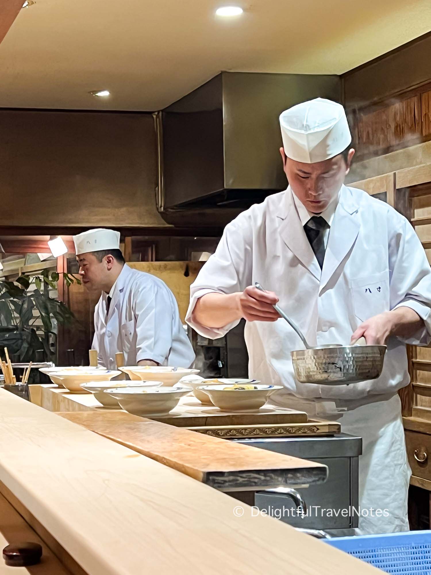 Hassun chef and his assistant preparing food at the counter.