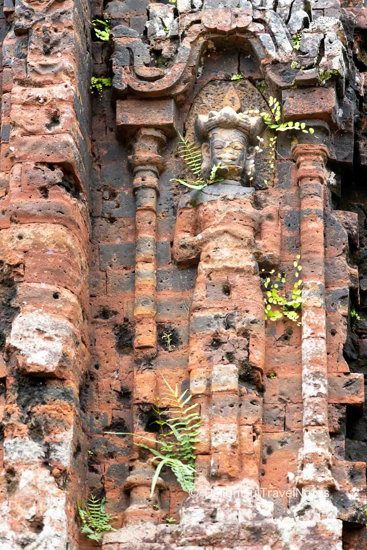 close up look of carvings on the brick wall of My Son temples in Vietnam.