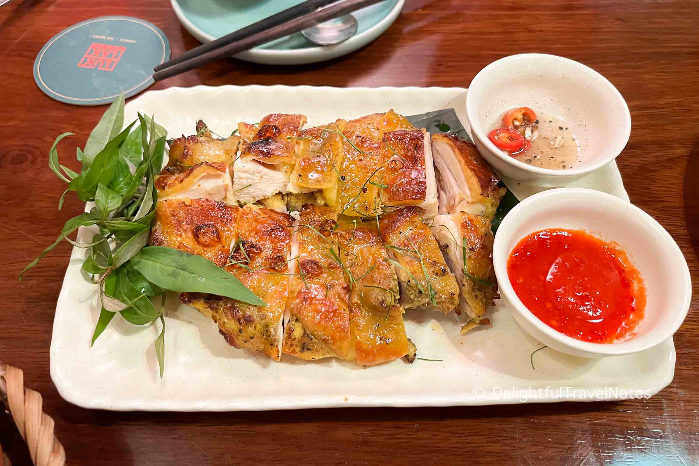 a plate of grilled chicken at LUK LAK restaurant.