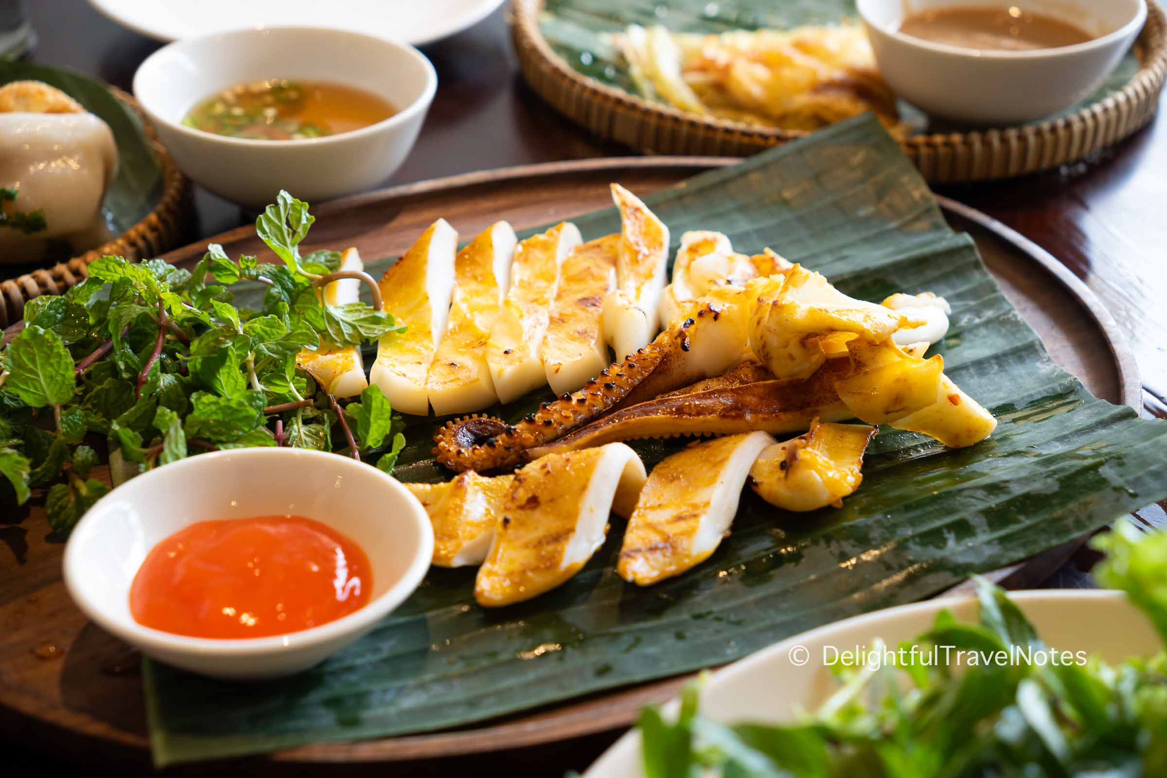 a plate of grilled semi-dried squid (muc mot nang nuong) at Madame Lan restaurant in Da Nang, Vietnam.