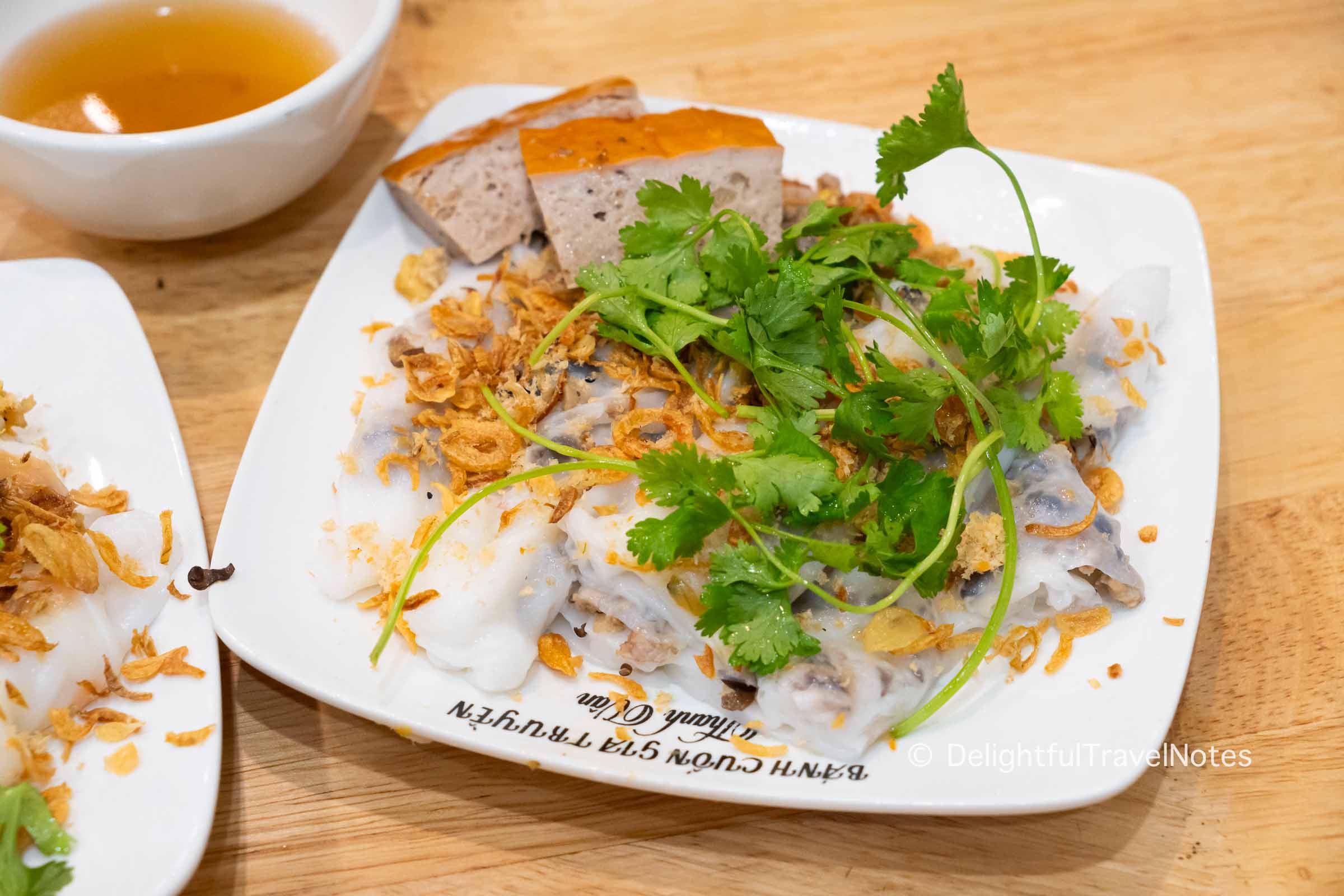 a plate of steamed rice rolls at Banh cuon Thanh Van, the best banh cuon stall in Hanoi.