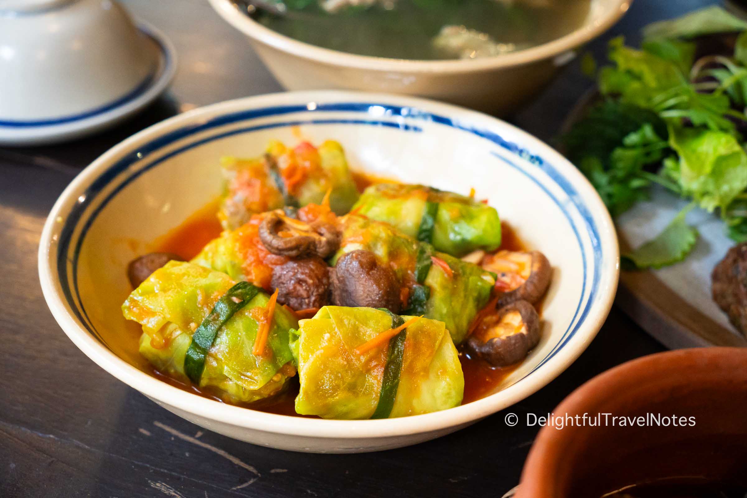 a plate of cabbage rolls in tomato sauce at Tam Vi restaurant in Hanoi.