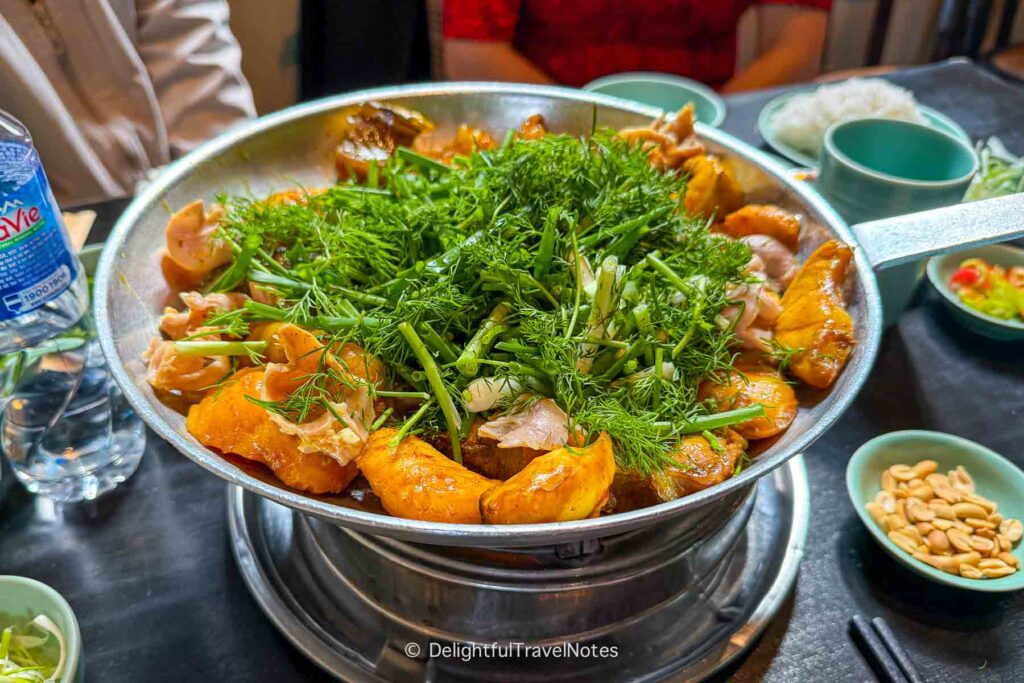 a skillet of turmeric fish with dill at Cha Ca Thang Long, a must-try restaurant in Hanoi.