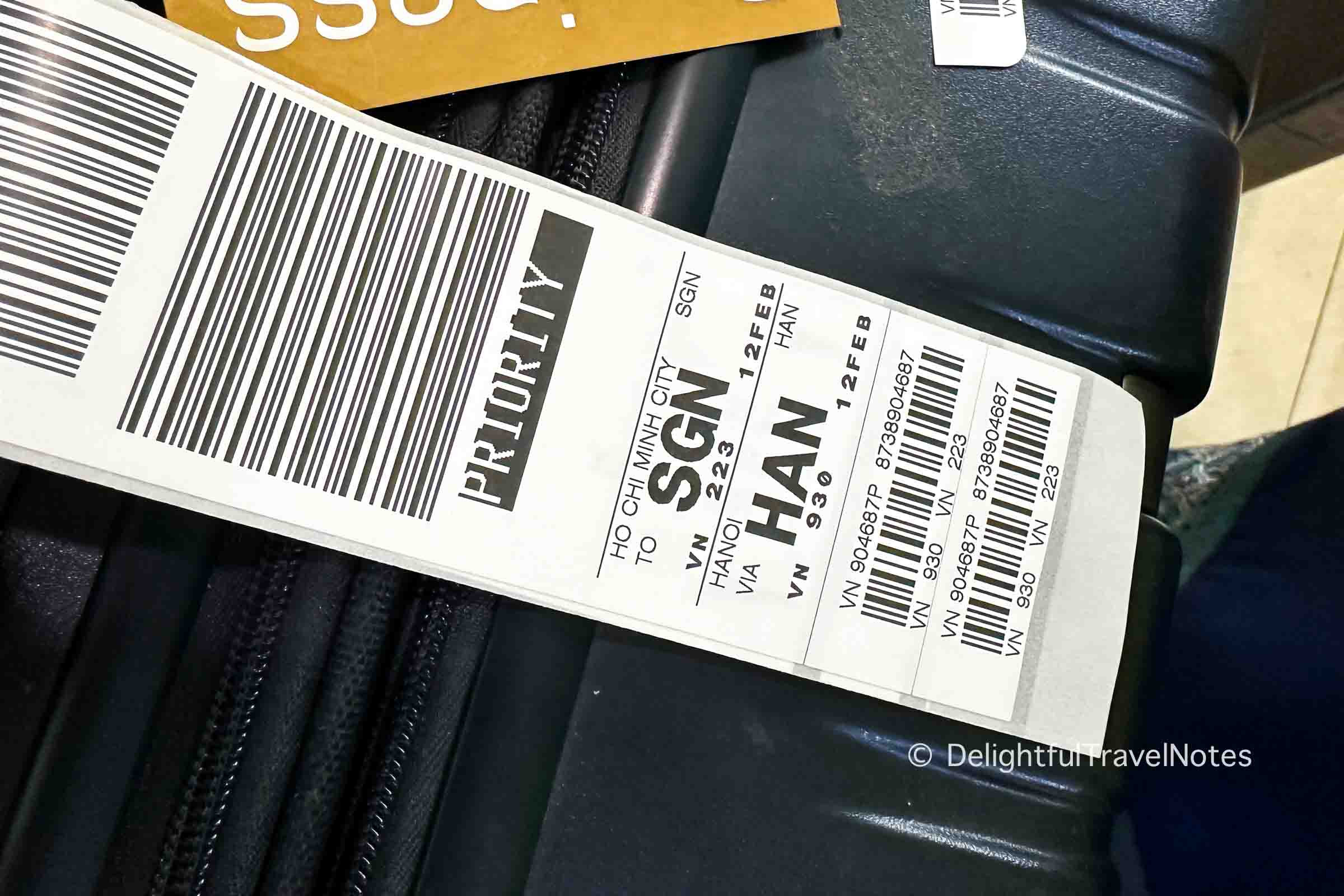 a luggage tag of Vietnam Airlines to Ho Chi Minh City with transit at Noi Bai International Airport in Hanoi.