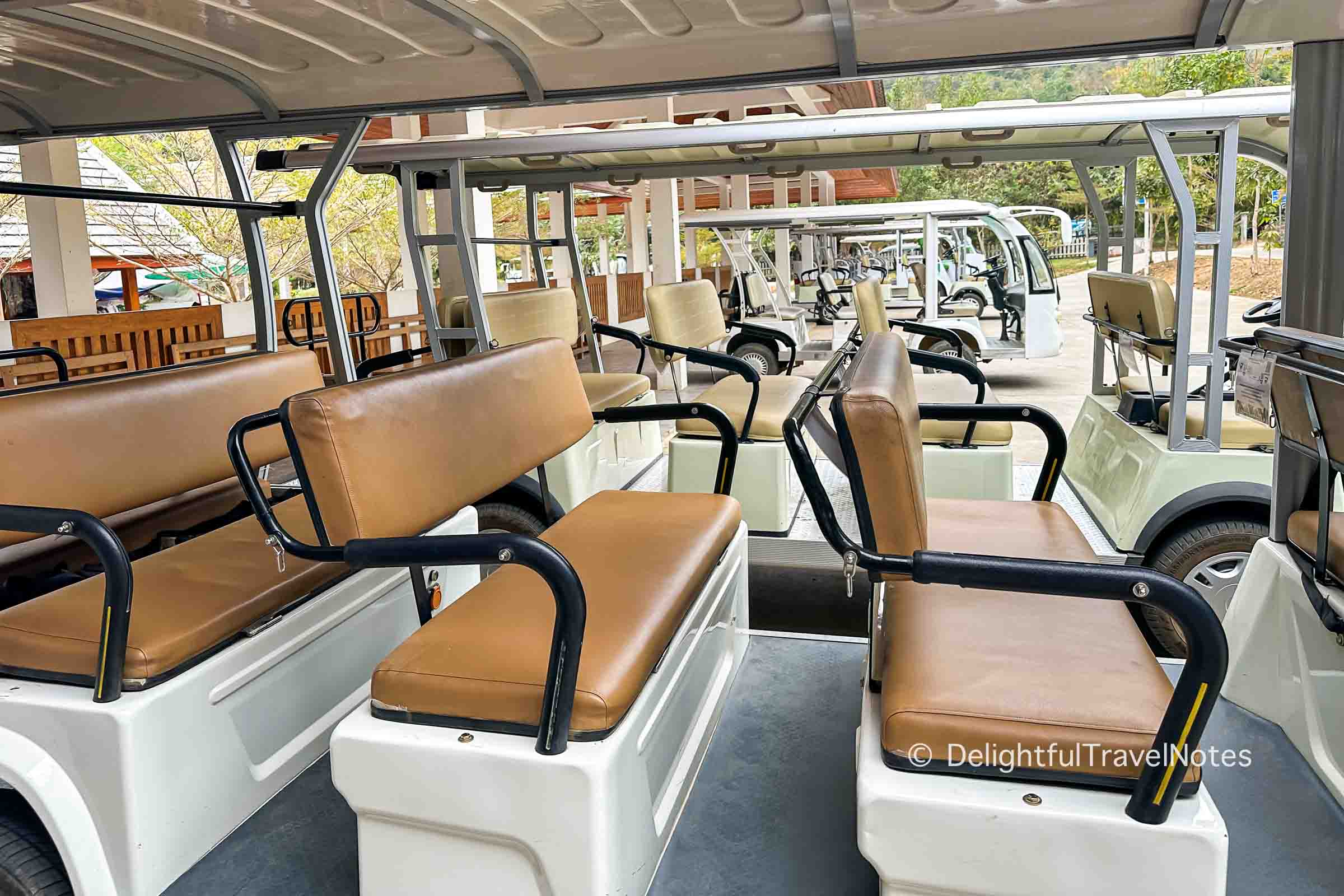 Electric shuttles to Kuang Si Falls park entrance.