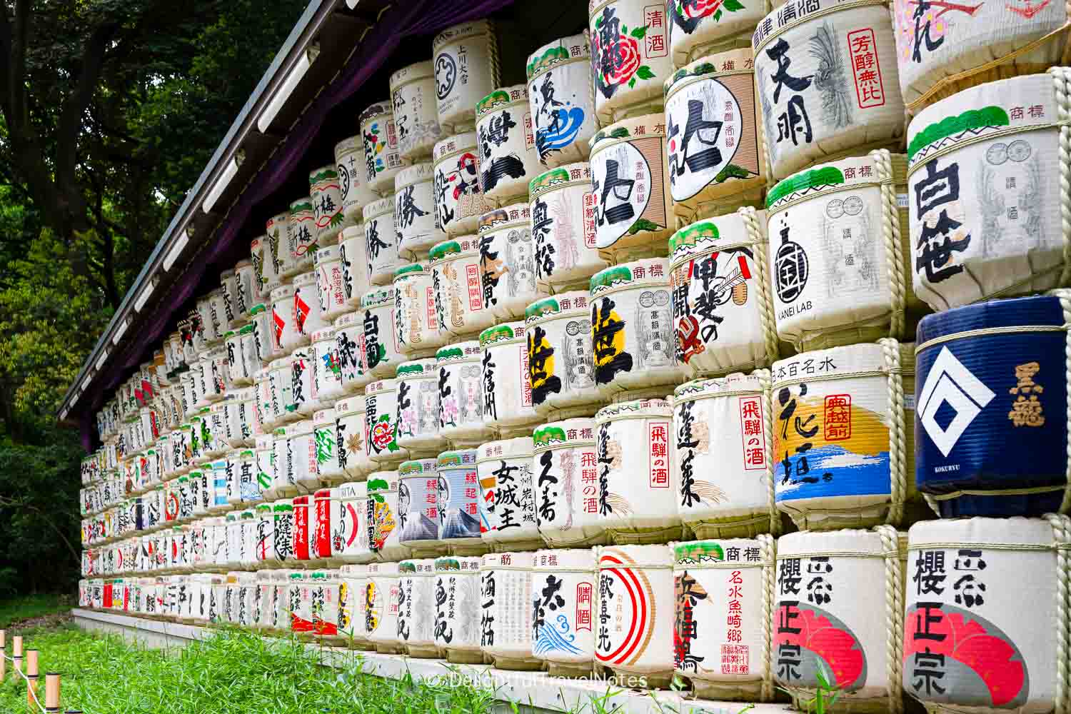 stacks of colorful sake barrels at Meiji Jingu in Tokyo.