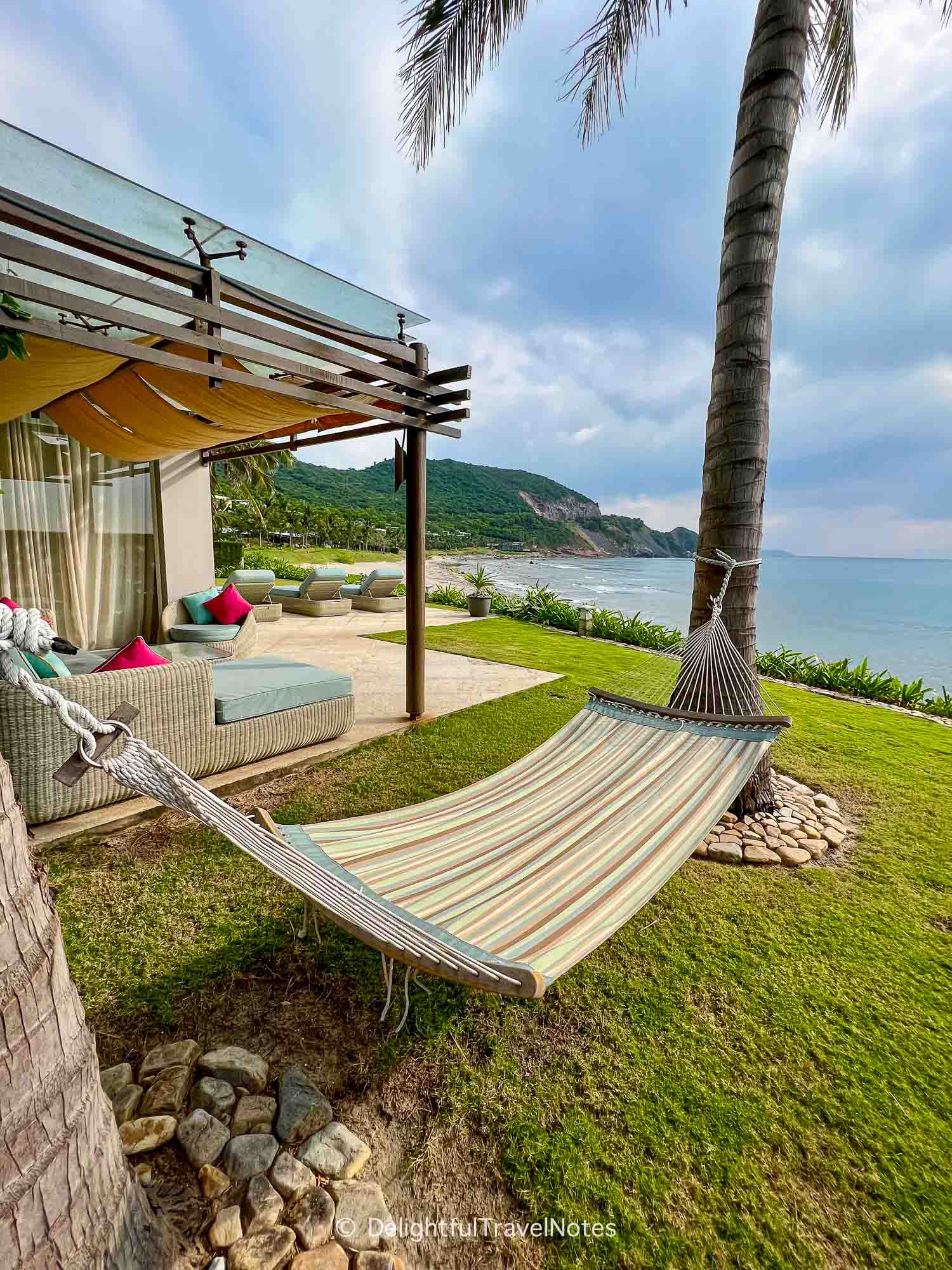 villa garden with a hammock overlooking the sea at Mia Nha Trang Resort.