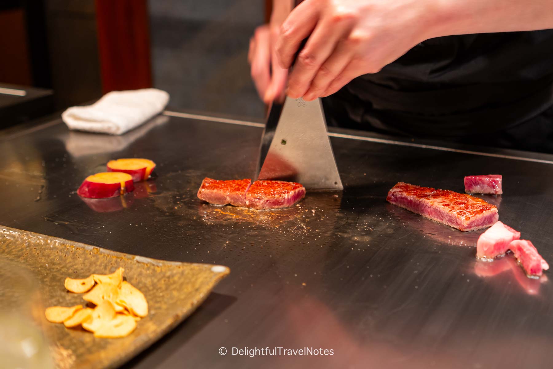 a chef cooking the wagyu sirloin on the teppan at Beef Steak Ishida in Kobe.