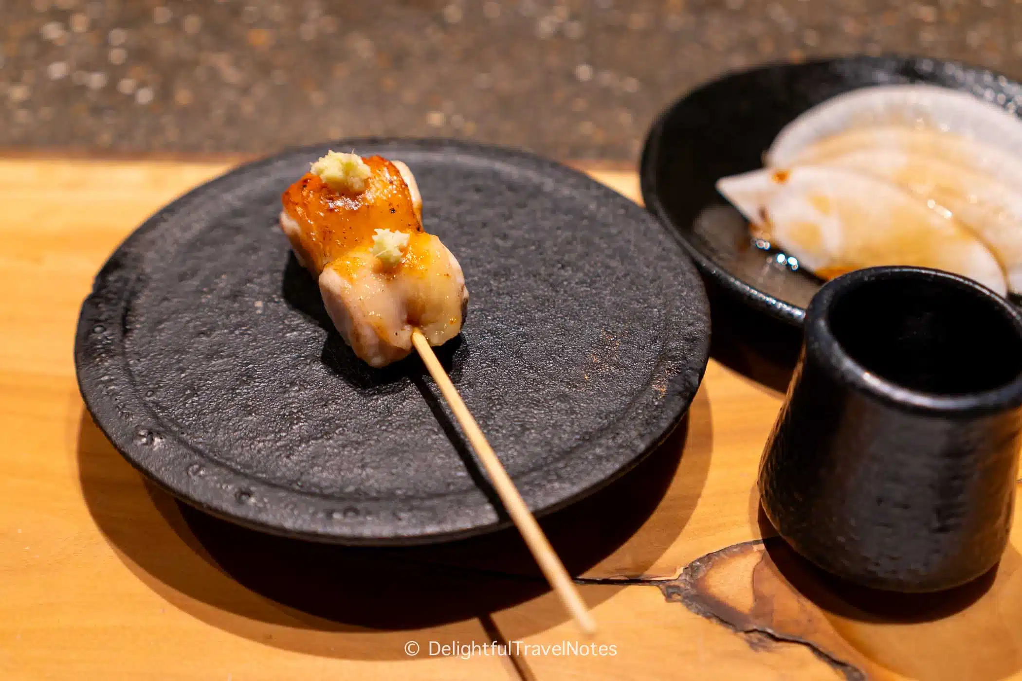 a grilled chicken thigh skewer at Yakitori Taimatsu in Osaka.