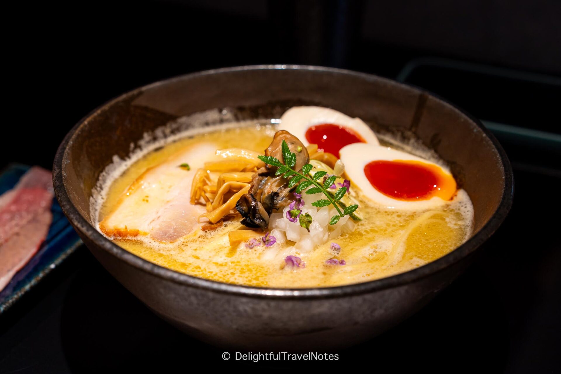 a bowl of oyster ramen at Next Shikaku, a must-try ramen place in Osaka.