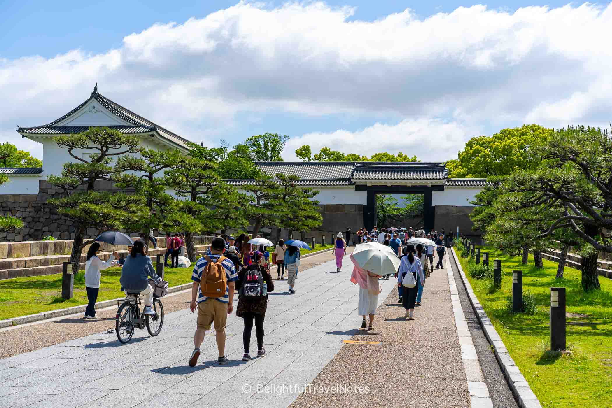 the walkway to Osaka Castle with many visitors.