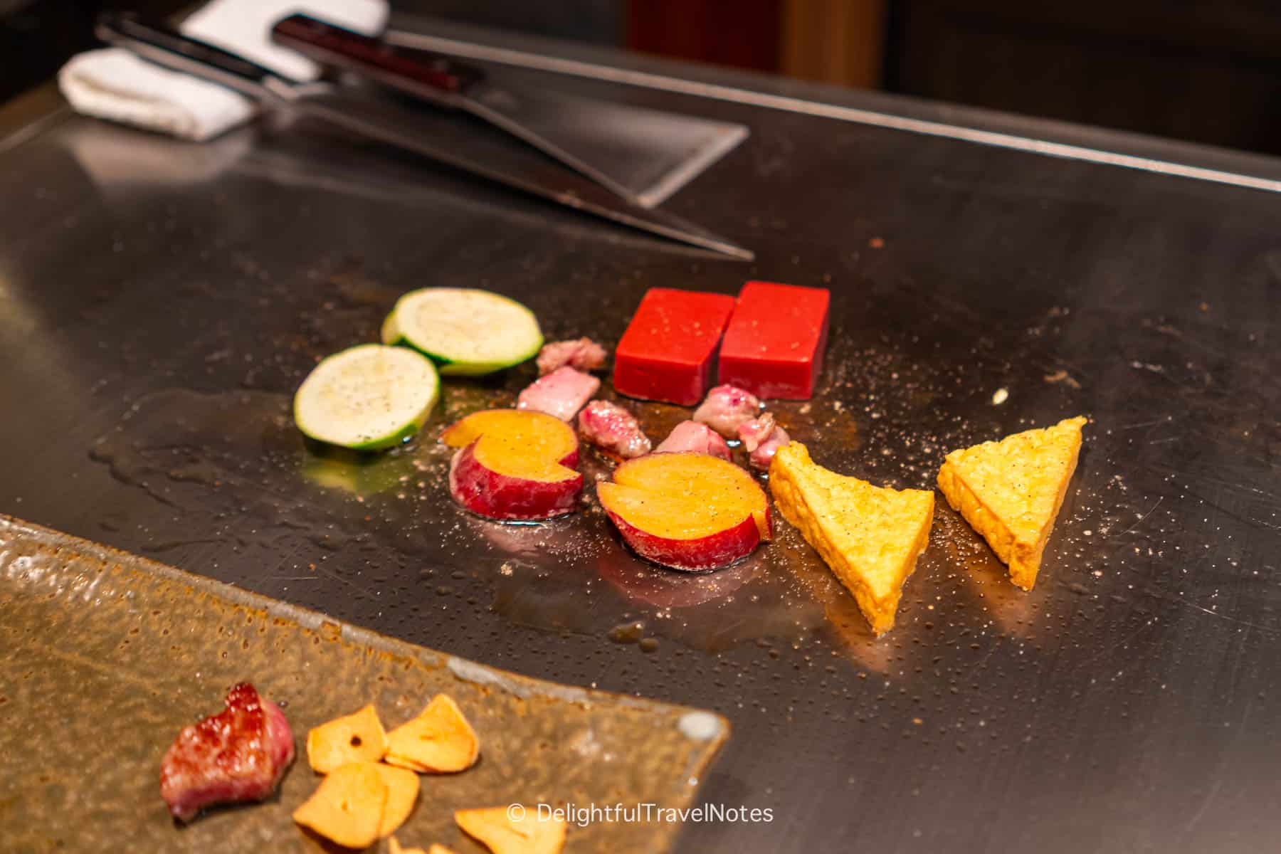 vegetables being grilled on the teppan.