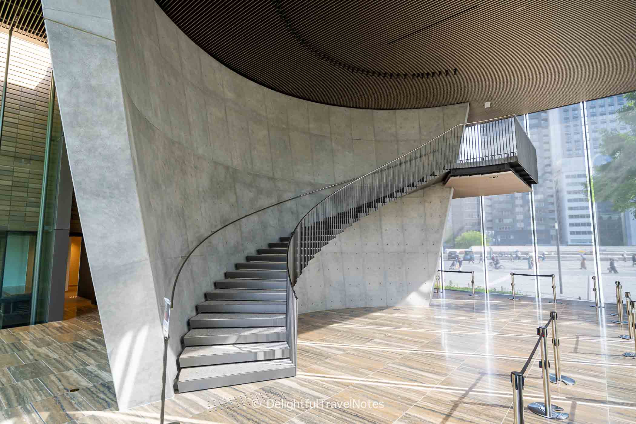 the staircase in the entrance hall of the museum, bathed in afternoon light.