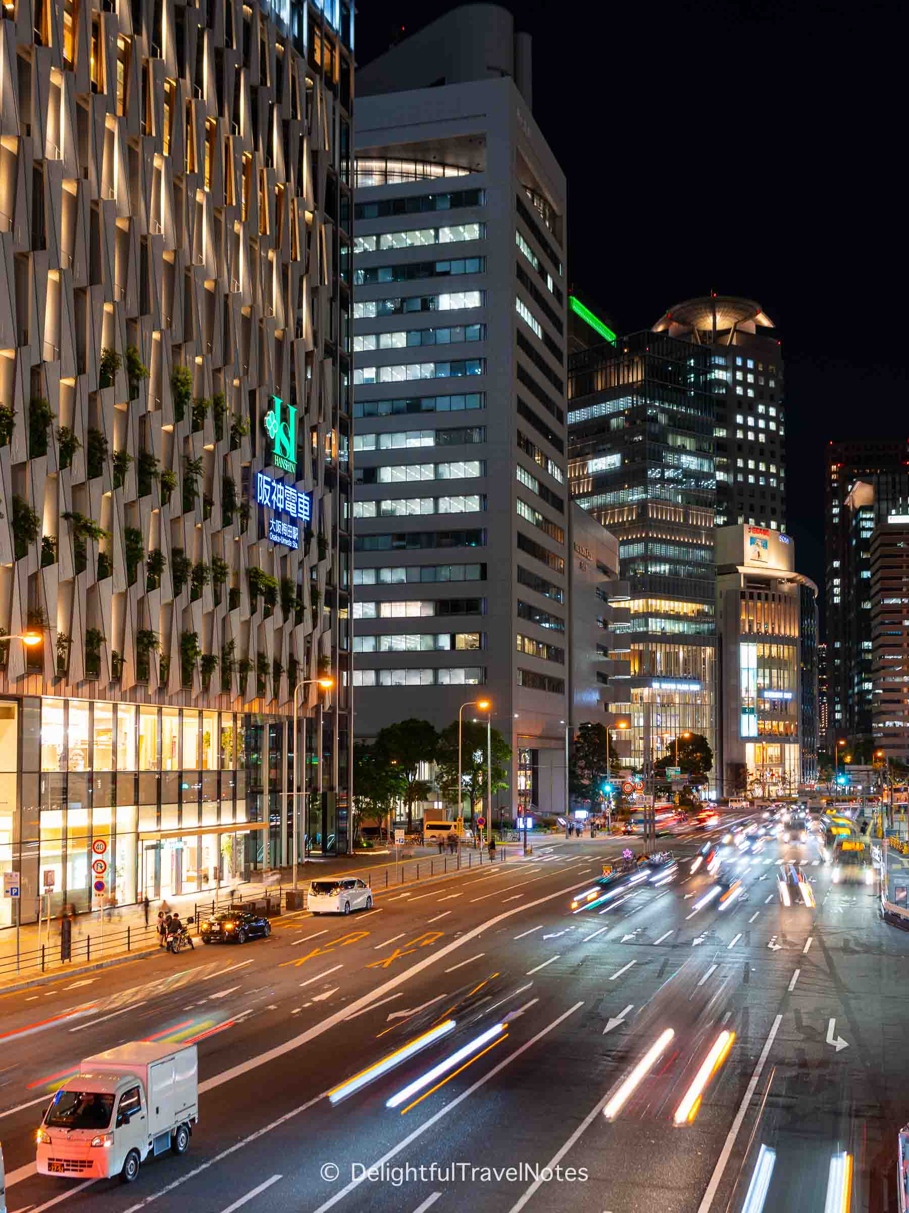 Umeda cityscape at night viewed from Osaka Station crossing bridge.