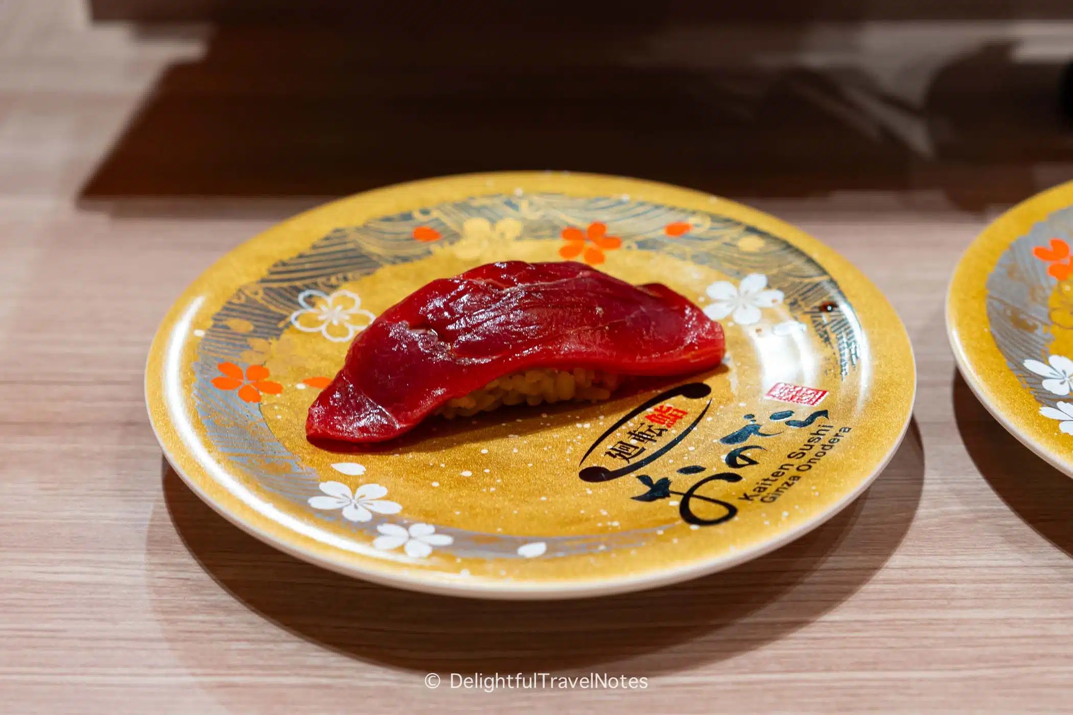 a piece of akami nigiri at Kaiten Sushi Ginza Onodera, upscale conveyor belt sushi in Japan.