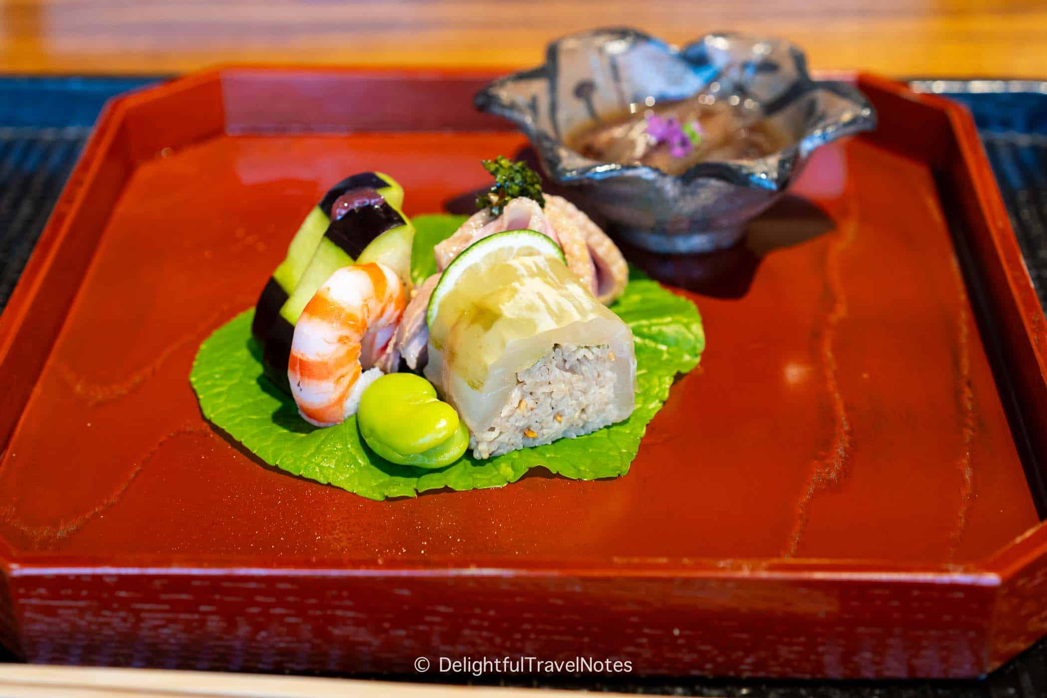 a plate of soba sushi roll, poached shrimp and roast duck at Kyoumi Kai in Kanazawa.