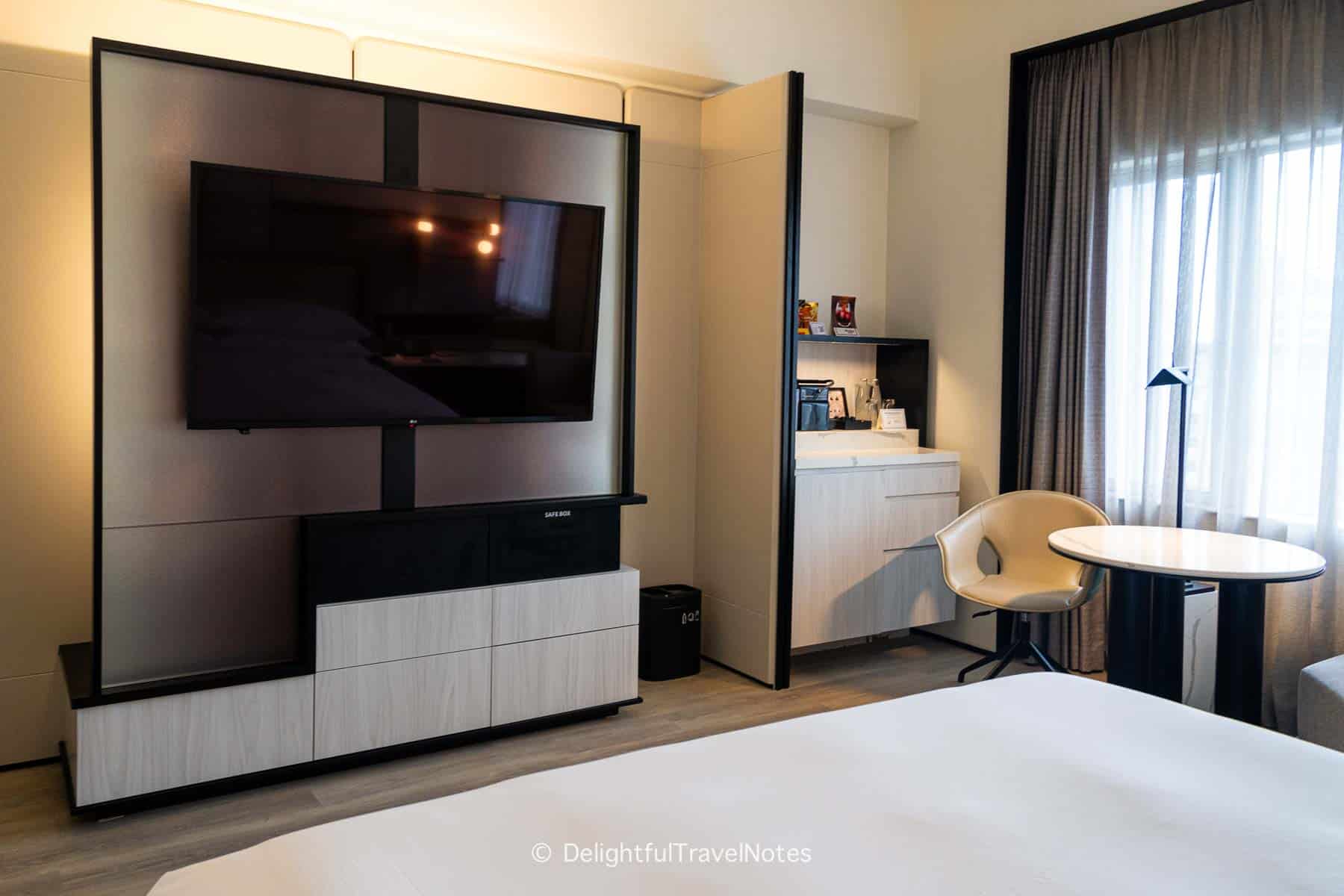 the TV console with hidden hanging racks in the guest room at Hilton Singapore Orchard.