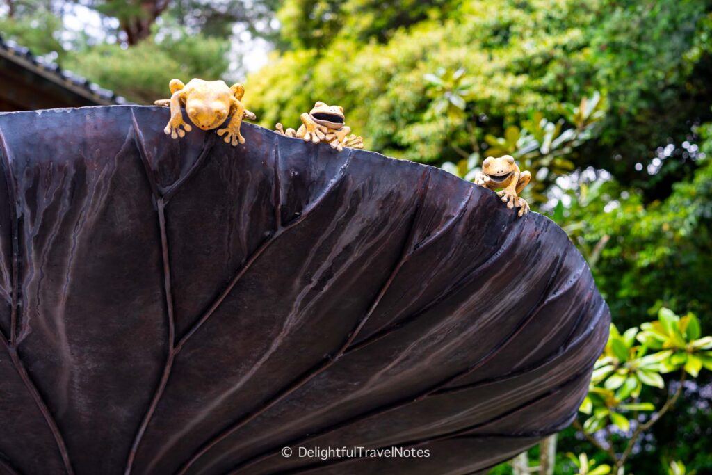 whimsical sculpture of frogs on Oyama shrine grounds in Kanazawa.