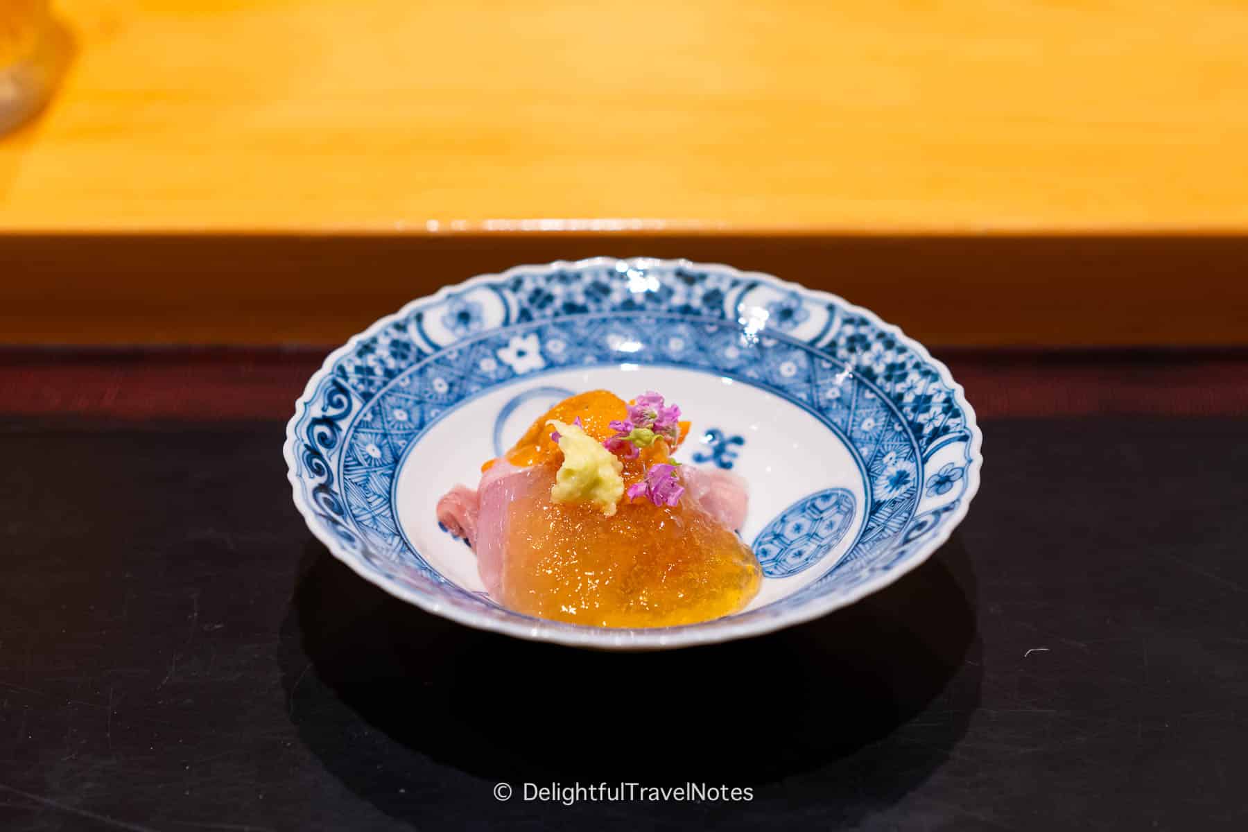 a plate of uni and fresh fish slices at Sushi Issei.