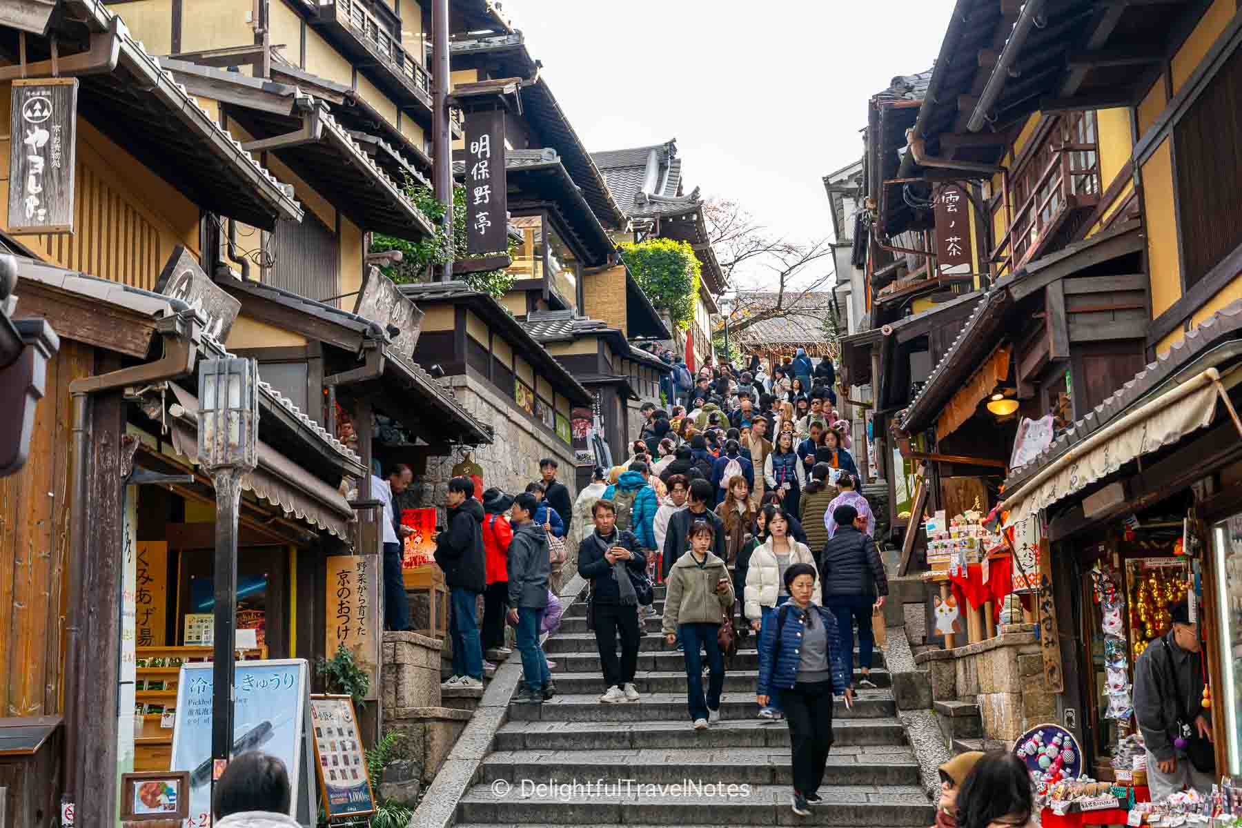 Sannenzaka and Ninenzaka streets leading to Kiyomizu-dera packed with tourists in autumn in Kyoto.