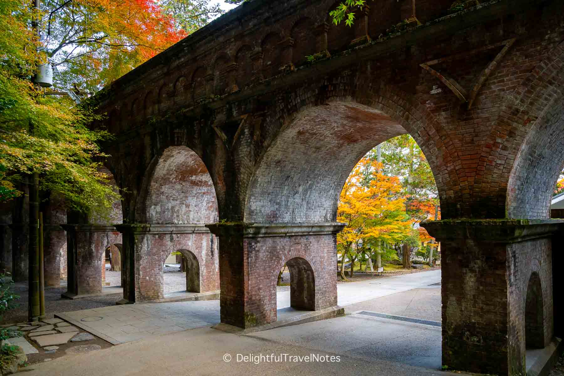 Fall foliage viewed through Nanzen-ji Suirokaku arches.