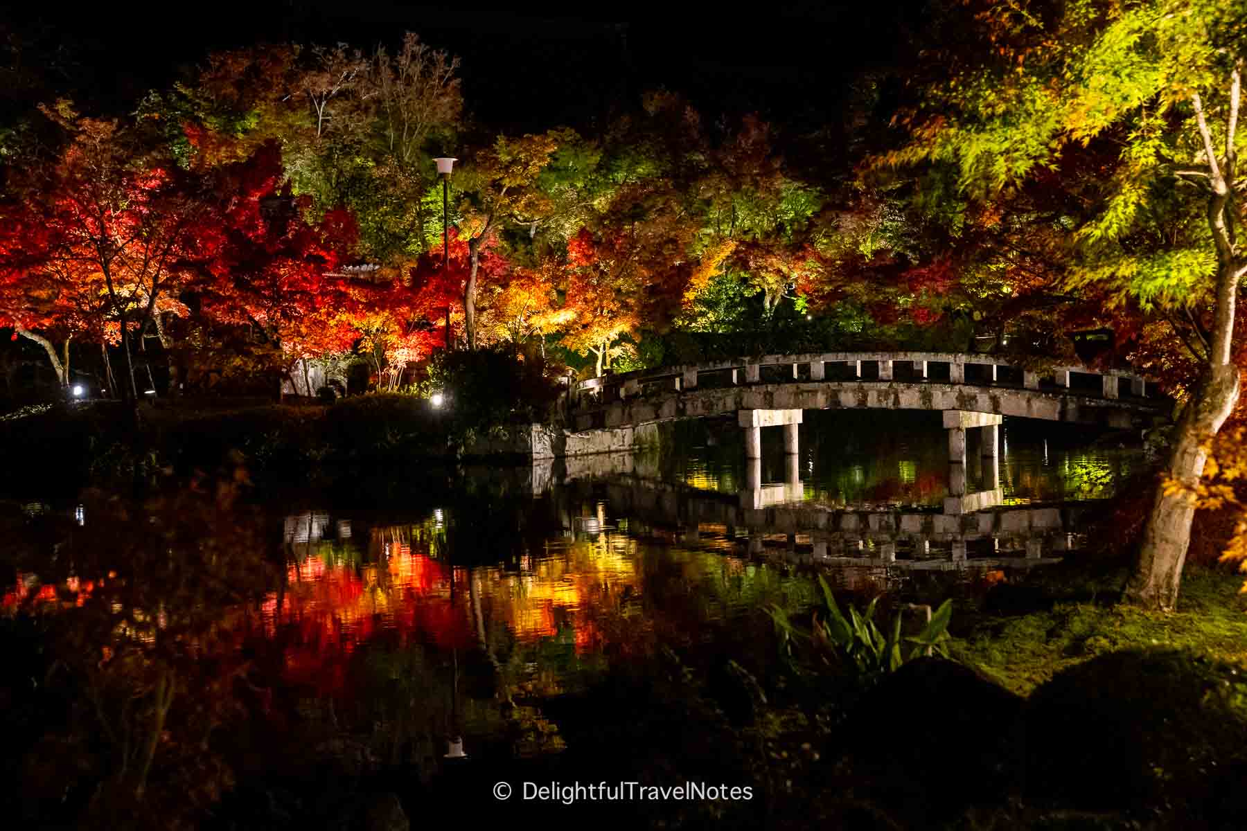 Hojo-pond with the bridge and foliage reflection during night illuminations at Eikan-do in Kyoto.