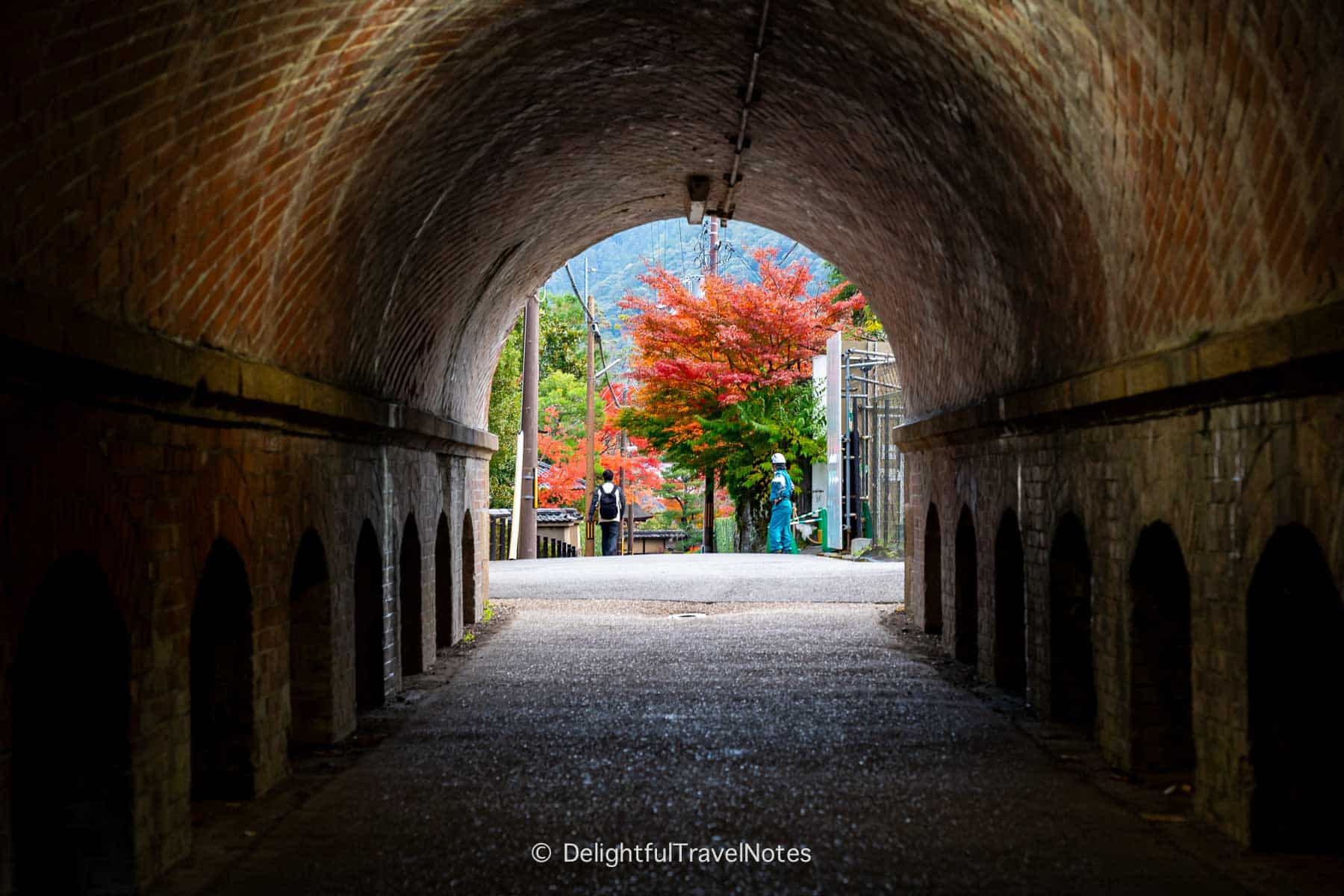 view of the path and foliage through Keage Tunnel in Higashiyama, Kyoto in the fall.