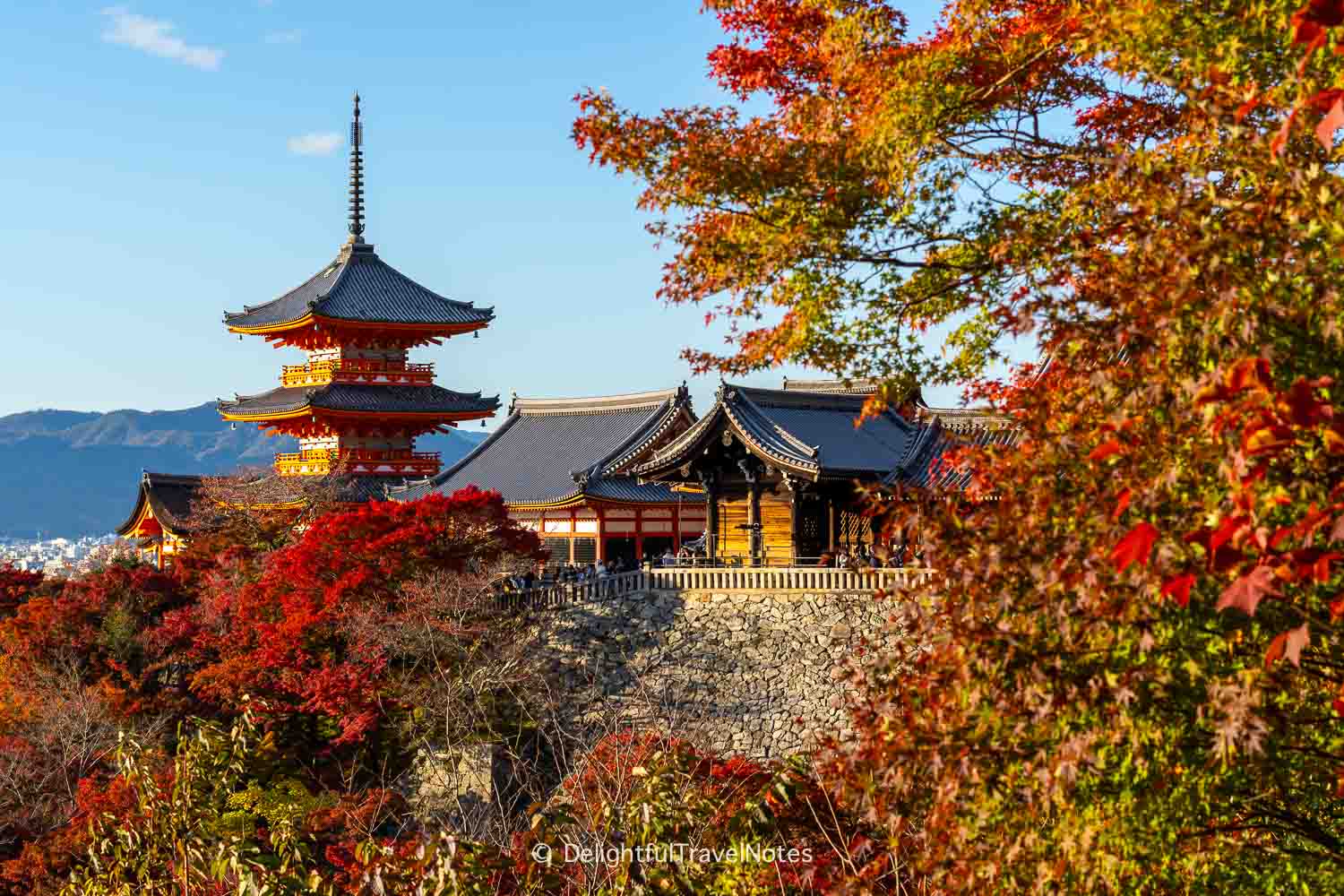 view of Sanjunoto, Kiyomizu-dera's three-storied pagoda framed by vibrant fall colors.