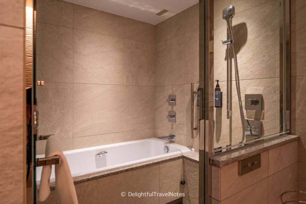 Shower and bathtub in guest bathroom at The Westin Miyako Kyoto Hotel.