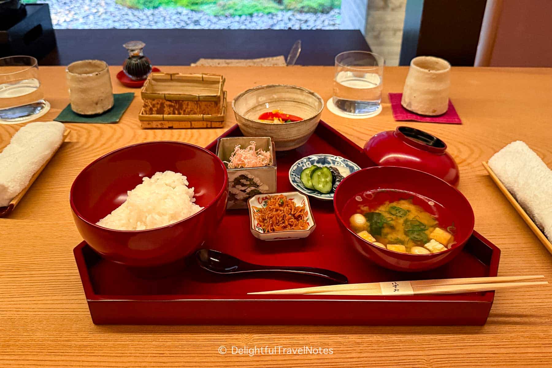 a tray with steamed rice and miso soup in the Japanese breakfast at The Hiramatsu Kyoto.