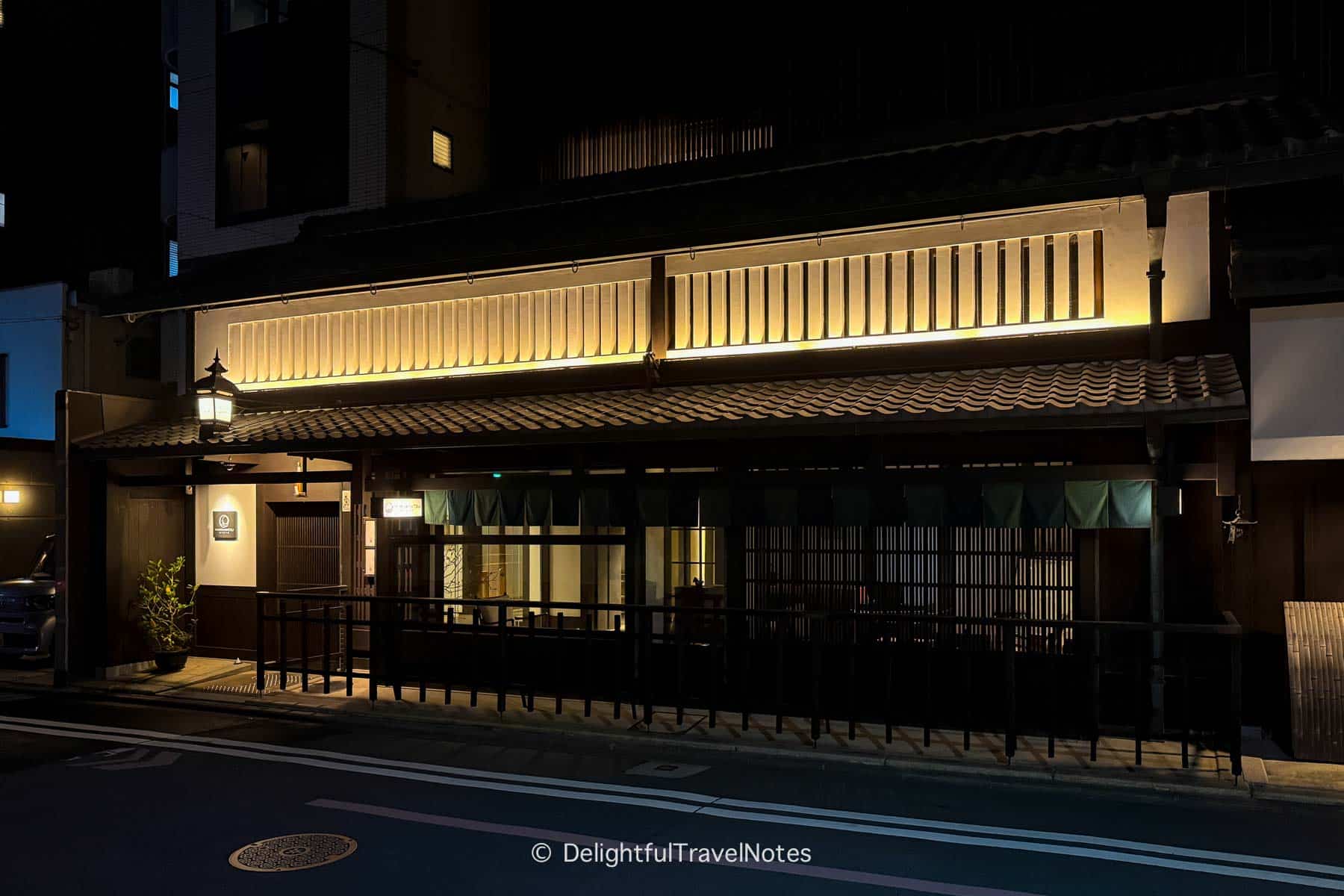 the facade of the hotel at night.