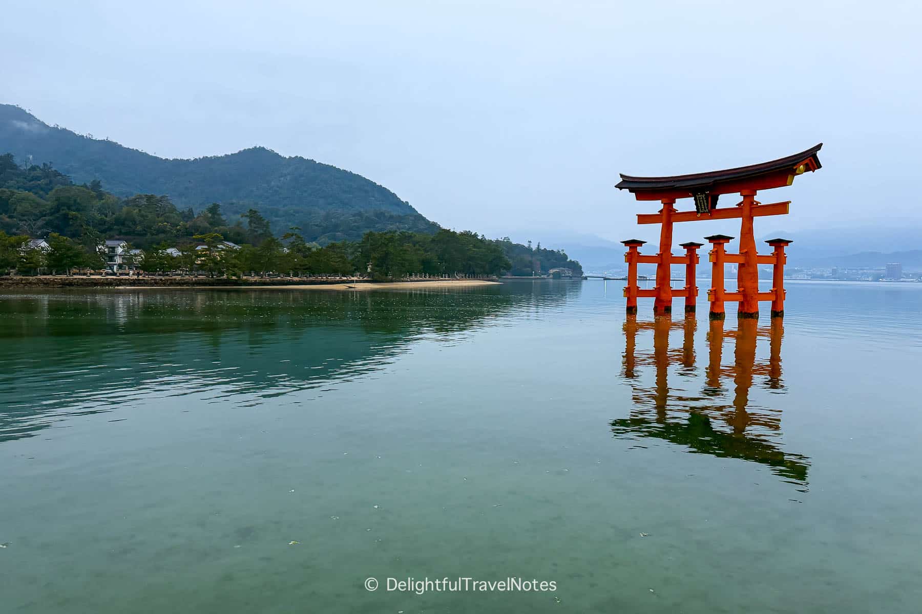 Itsukushima Shrine floating torii with its clear reflection over the water.