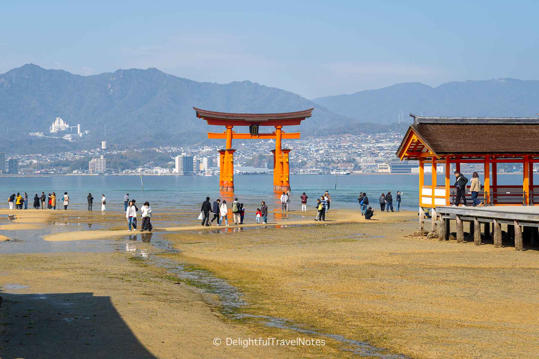 Low tide inside Itsukushima Shrine on Miyajima island at noon.