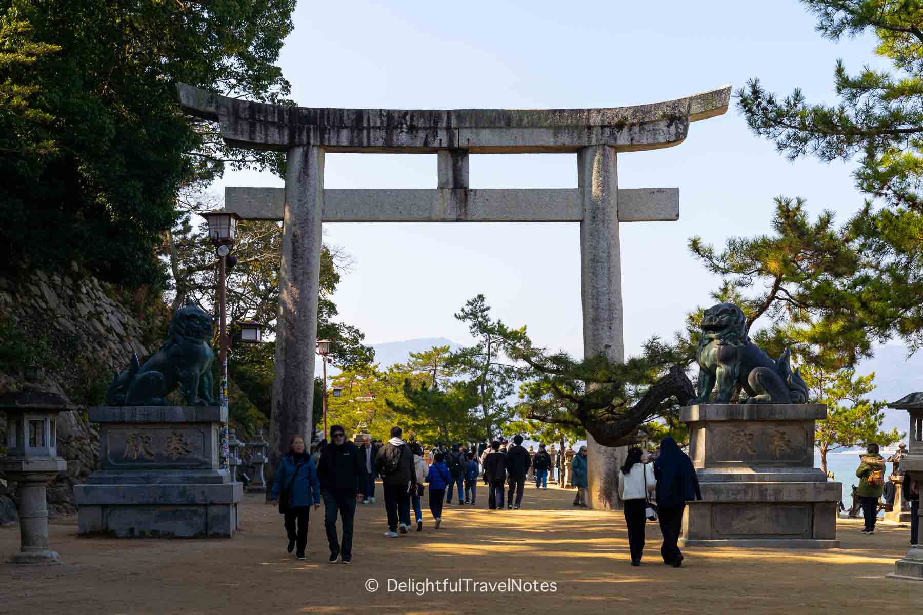 a stone torii on the path to Itsukushima Shrine on Miyajima.